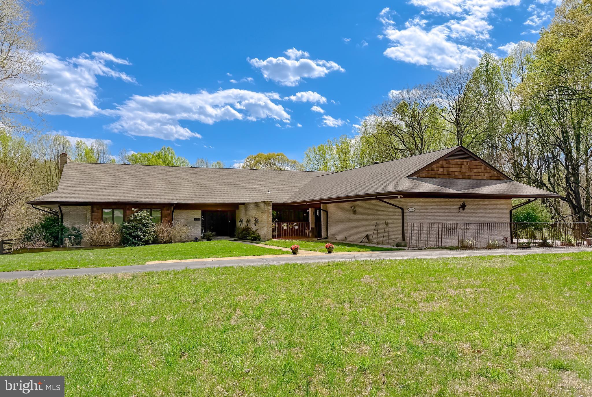 An amazing mid -century home flooded in natural light minutes from downtown La Plata, located in the well-established Kerrick Manor neighborhood is ready for your viewing. This home is situated on 2 beautiful acres and has access to a large pond for fishing, enjoying, entertaining or simply relaxing. This property is a remarkable find with an additional 2-acre adjacent lot included in this offering. The value of this provides great privacy and post card perfect views of a peaceful, natural setting. The home is entirely built of brick, with numerous courtyards, patios and a full-length deck out of the rear of the home. Enter the home and immediately you are enveloped with brick walls, hardwood floors, abounding natural light and views of the sunken living room with vaulted ceiling and inviting fireplace. There is a notable room with pecky Cyprus paneling also off the foyer that can be used as a home office or guest room. The dining room is large and perfect for formal or casual dining. The primary bedroom is also filled with windows, quite spacious and relaxing. The kitchen has wonderful original cabinets with many built-ins, all with granite countertops and ready for making gourmet dinners and is also a great venue for a casual dinner serving area. Off the kitchen is a casual dining area, an intimate seating area for watching tv, or enjoying a memorizing fire in a second fireplace, and access to a covered porch area with garden views.

There is an entire lower level for family and guests accessed by an open, brick-walled staircase.  This level features a large family and game room space with outside exit, this expansive room opens to a large patio accessed through a full wall of windows and sliders from the three bedrooms, or one can serve as a workroom, full ceramic bath with separate shower and bath tub and a rough in for a kitchen if one needs multigenerational living space. 

The property has easy access to Routes 6, 301 and 225 making commuting to all area bases, DC and Virginia and airports easy and seamless.
