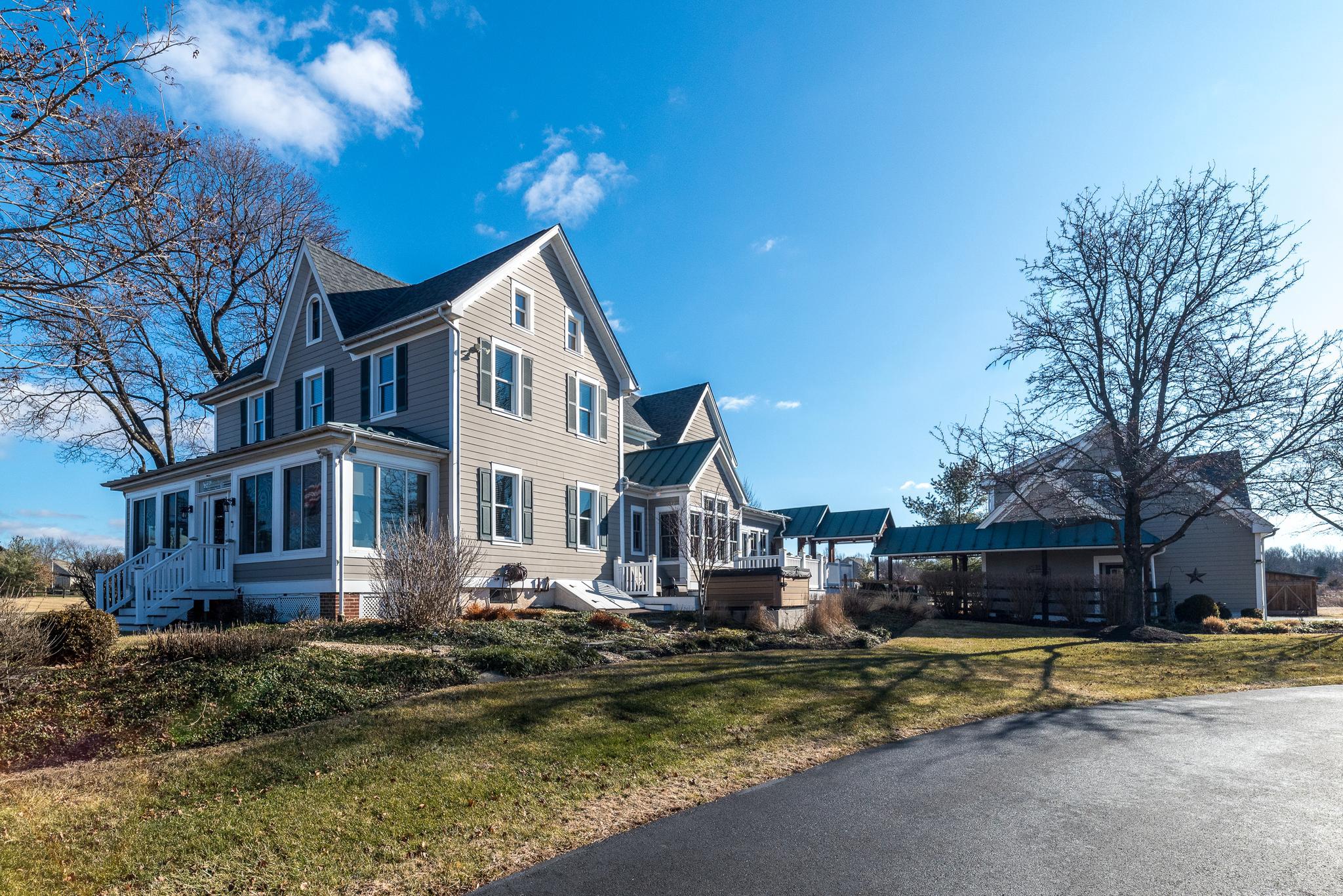 Embrace the Allure of This Home in a Prime Location — 40 Foellner Lane, Ottsville, PA. Discover a rare private sanctuary in Nockamixon Township, set on 10.89 breathtaking acres with your very own scenic pond and iconic windmill. This beautifully transformed 1890 farmhouse has been expertly reimagined by renowned Bucks County architect and builder George J. Donovan. Tucked away on one of Upper Bucks County's most secluded roads, it offers tranquil views of open farmland and Haycock Mountain—the highest peak in Bucks County at 974 feet, also known as Ghost Mountain.
This cheerful home is filled with natural light, thanks to an abundance of energy-efficient windows that provide peaceful views from nearly every room. Beautiful hardwood floors grace the interiors, enhancing the inviting atmosphere.
Enter through the delightful enclosed porch, adorned with rich mahogany floors and tall insulated windows — a serene sitting area perfect for relaxation, reading, or enjoying spectacular sunsets over Haycock Mountain and the nearby farm. This welcoming entrance gracefully leads into the formal living and dining rooms, showcasing elegant coffered ceilings that enhance the home's sense of space and grandeur.
At the heart of the home lies a truly exceptional chef’s kitchen, featuring:
• State-of-the-art appliances, including a Wolf range with six gas burners, a flat griddle cooktop, and dual ovens
• A built-in Wolf microwave convection oven
• A commercial Sub-Zero refrigerator/freezer with a stainless steel interior
• Two-drawer Fisher & Paykel dishwashers
• A massive quartz island, multiple sinks, a separate wet bar/coffee bar, and a spacious walk-in pantry
The bright eat-in area, with its bump-out overlooking the expansive lawn and scenic pond, seamlessly flows into the warm and inviting family room, which boasts a wood-burning fireplace and a large wall of windows revealing stunning views of the back property.
Upstairs, discover a luxurious primary suite — an elegant owner’s retreat featuring:
• Two spacious walk-in closets
• A beautifully updated en-suite bathroom with washer/dryer
Three additional bedrooms complete the upper level, one with its own private bathroom. The lower level of the main house also includes a functional office area. An expansive walk-up attic on the third floor, featuring cedar walls, offers abundant storage and easy stair access.
Above the heated and air-conditioned three-car garage, a private guest or in-law suite awaits, connected by a breezeway with a tin roof — ideal for extended family, guests, or as a personal retreat.
The lower level also includes a clean, functional basement area that houses the whole-house water conditioning system with a UV filter, ensuring pristine water throughout the property.
Professionally landscaped grounds beautifully surround the home. A covered back porch serves as the perfect spot to enjoy the gentle breezes coming off the open land. Unwind on the Trex deck with a hot tub and soak in the tranquility of your private, park-like acreage. Just steps away is Nockamixon State Park and the expansive 1,450-acre Lake Nockamixon — a boater’s and angler’s paradise offering sailing, kayaking, canoeing, fishing, and more. The park also features miles of hiking and biking trails, along with a swimming pool.
Conveniently located near Ottsville, explore Linden Hill’s botanical gardens, the unique Ringing Rocks, and the Delaware River, all just minutes away. Peddler’s Village, the Bucks County Children’s Museum, Doylestown, and New Hope are all a short drive away for shopping, dining, and entertainment.
Impeccable finishes, thoughtful custom details, and unmatched privacy deliver the ultimate Bucks County lifestyle — a true escape into peace, natural beauty, and timeless elegance.