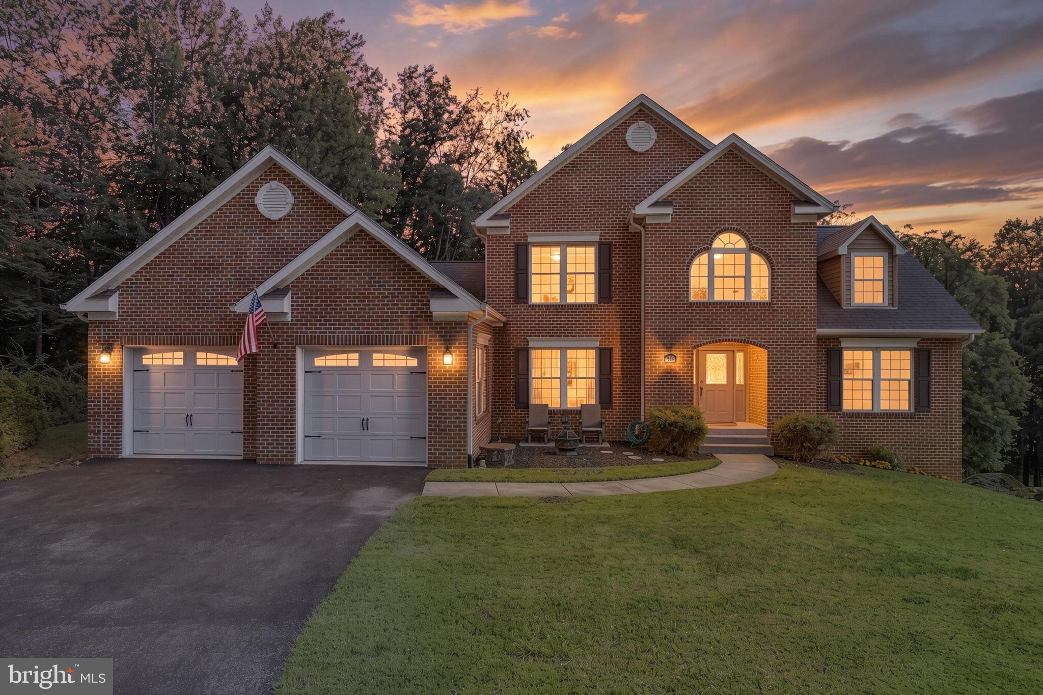 Nestled on a picturesque 1.63-acre homesite just minutes from historic Downtown Frederick, this beautifully maintained one-owner residence offers the perfect blend of space, comfort, and thoughtful updates—all with no city taxes. Featuring five bedrooms, three full baths, and two half baths, this exceptional home is designed for both everyday living and effortless entertaining.Step inside to a grand two-story foyer with an impressive oak staircase, formal dining room with tray ceiling and columns, and a stunning two-story great room filled with natural light from a dramatic wall of windows and anchored by a cozy gas fireplace. The spacious kitchen opens seamlessly to the main living areas, while two main-level primary suites with private baths provide exceptional flexibility for multi-generational living or guest accommodations. A beautifully updated laundry room features custom upper and lower cabinetry with granite countertops, adding both style and functionality.Upstairs, you'll find three generously sized bedrooms, a full bath, and an open hallway overlooking the great room below. The expansive lower level is fully heated and cooled and includes a recently added half bath with Brazilian cherry flooring, offering outstanding potential for a recreation room, home gym, media room, or additional living space.Outdoor living is equally impressive. A 336-square-foot Trex deck (2023) overlooks peaceful wooded surroundings, creating the perfect setting for relaxing or entertaining. The property also features two inviting fire pit areas—one with a charming sitting area near the front of the home and another nestled within the original stone walls of the former bank barn—offering unique spaces to gather and enjoy the outdoors.Numerous recent improvements provide peace of mind, including new basement air handler (2024), both exterior HVAC condenser units (2024), upstairs air handler (2019), Whirlpool refrigerator (2024), Samsung microwave (2024), and more. Additional highlights include an oversized two-car garage with built-in storage cabinets, a large storage shed, and an extensive list of valuable items that convey, including multiple mounted televisions, custom window treatments, LG washer and dryer, deck furniture, Char-Broil infrared grill, garage cabinetry, extension ladder, and Craftsman snowblower.Conveniently located near major commuter routes including US-15, I-70, and I-270, this exceptional property offers easy access to shopping, dining, parks, wineries, and all the charm, entertainment, and events of Downtown Frederick. For those seeking additional equipment, a John Deere E140 riding mower with baggers and utility cart is available for purchase separately. This is a rare opportunity to own a meticulously cared-for home offering timeless appeal, modern updates, and an unbeatable Frederick County location.