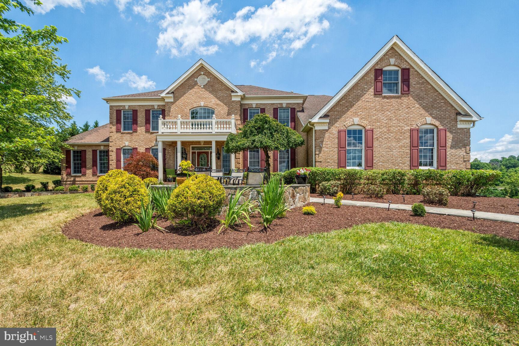Welcome to 17586 Tobermory Place! This four-sided brick Toll Brothers Hampton model offers just over 8,000 square feet of fully finished living space and is gracefully positioned on a 3.5-acre corner lot in coveted Shenstone Farm. As you approach along the stone-paved walkway, you're welcomed by sweeping panoramic views and timeless curb appeal. Inside, you'll find hardwood floors on the main and upper levels, brand-new carpet in the lower level, and a built-in Russound system that flows throughout the interior & exterior of the home—perfect for both everyday living and entertaining. The backyard invites endless possibilities—design your dream outdoor sanctuary with space for a pool, entertaining terrace, or peaceful garden escape! Step inside the grand foyer, where dual curved staircases open to a sun-drenched two-story family room, anchored by a striking floor-to-ceiling stone wood-burning fireplace. The expansive eat-in kitchen features granite countertops, a large center island, and stainless steel appliances that flow seamlessly into a formal dining room—ideal for gatherings and special occasions. A well-appointed home office offers tranquil views of mature evergreens, while an adjoining sunroom floods the space with natural light and scenic beauty. Upstairs, the luxurious primary suite serves as a private retreat, complete with a tray ceiling, cozy sitting area, fireplace, and two generously sized walk-in closets. The spa-inspired bathroom includes a soaking tub, separate shower, dual vanities, and a convenient laundry chute. Three additional upper-level bedrooms each include en suite bathrooms and walk-in closets, offering both privacy and comfort for family or guests. The fully finished lower level adds versatility with an additional bedroom and full bath, a second living area, a custom wet bar, a private home gym, a movie theater, and ample storage space. Enjoy breathtaking western sunsets while you unwind on the front patio! The home is conveniently located just minutes from historic downtown Leesburg, Route 7, and the Dulles Greenway, with easy access to shopping, dining, and Loudoun County’s renowned wineries. Recent improvements include: Heat pump replaced (2022), Dishwasher replaced (2023), New carpet in lower level (2024), Garage motors replaced (2024), Kitchen fridge replaced (2024), Sump pump replaced (2024) Washing machine replaced (2024).
