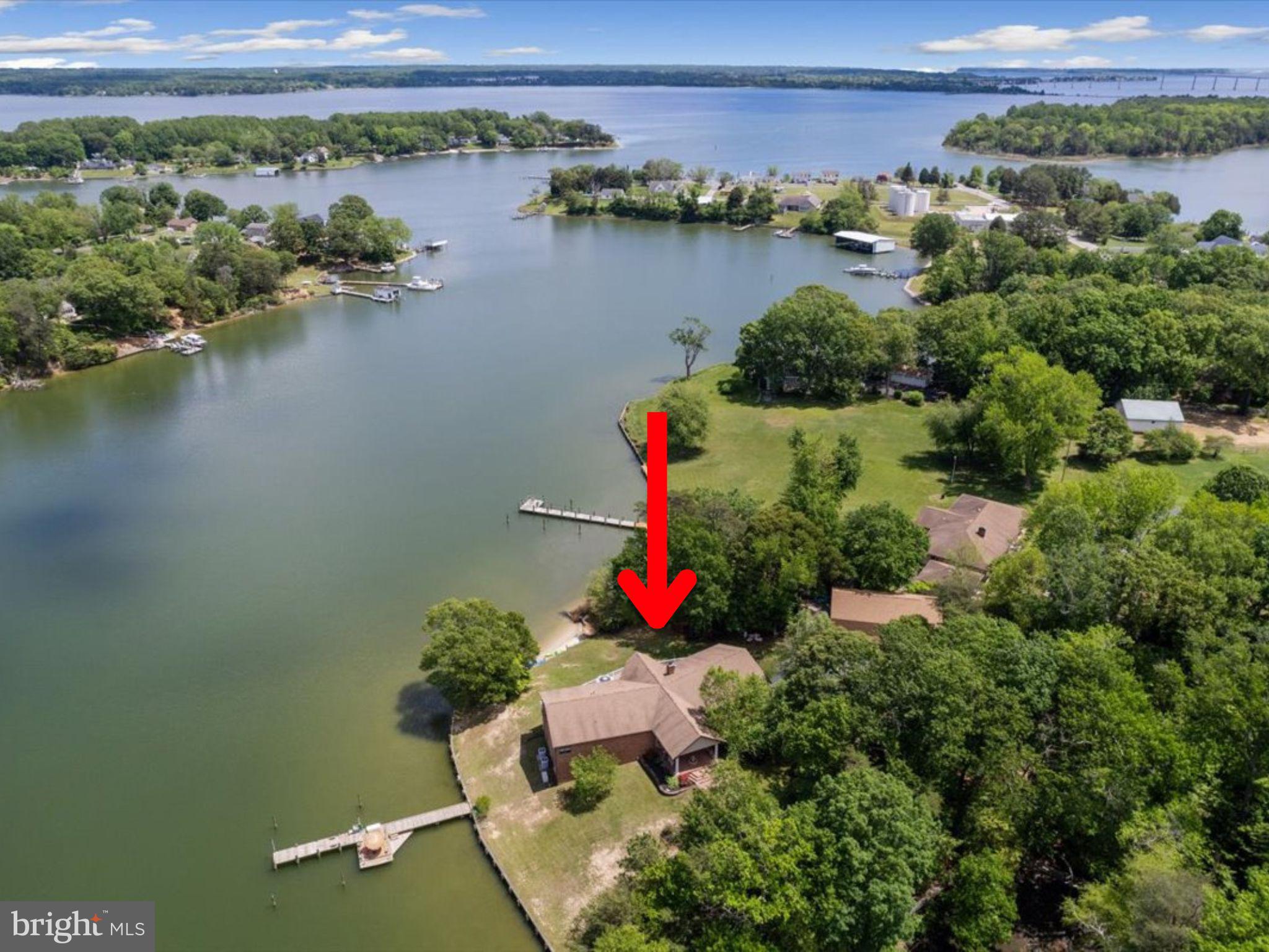 VERY PRIVATE POINT of land with all-brick sprawling residence was designed to take full advantage of the waterfront lifestyle at this unique site.  Cuckold Creek is highly sought after for boating and watersports, depth of water, surrounding value. This point has a unique private beach, a deep water private pier, and a beautiful elevation. Catch your own blue crabs at the pier and have summer crab feasts. Fish the Patuxent River, or be at the mouth of the bay in short order for cruising the Chesapeake Bay. Paddle board or kayak to cocktails just around the corner!  You will appreciate the high quality and low maintenance finishes, high ceilings on both levels, three fireplaces, beautiful hardwood floors, a generator, and many bedrooms with direct outdoor access. There are multiple locations for a home office and home gym within this 6500SF+ home . The kitchen is very large with an incredible amount of custom cabinetry and counter space, two refrigerators, 2 wall ovens, microwave, 2 DW, a 48" Wolf propane cooktop, an under counter beverage + ice maker and more. The primary wing on the main level is at the far corner of the house with radial views and direct deck access, a corner fireplace and gorgeous custom bathroom with stone finishes, a large walk-in shower and jetted tub. The guest wing on the main level has 3 more bedrooms, 2.5 baths and laundry/mud room. The centrally located dining room with tray ceilings,  formal living room plus waterside family room have gorgeous hardwood flooring and complete the heart of the home. THE FUN PART! Experience the ultimate in entertainment on the lower level. You'll love the high ceilings and creek views plus a perfect indoor- outdoor flow. A large bedroom suite is one of the two additional bedrooms and two full baths on this level, both with direct access to the covered patio.  The living space has a large stone fireplace that is wood-burning, a pool table area that is also great flex space for your favorite use.  The media room is ready for action, comes fully equipped. The bar area is great for big parties with its own booth seating and tiki bar highlight...this is a feature that your guests will never forget! DETACHED BUILDING. The all brick, 1536 SF detached building includes a 4 car garage, full bath on the garage level for use while at the beach/pier, plus a 1536 SF, 2BR/2BA apartment above. The apartment has a full kitchen, living room, dining area and laundry room.  It also has a large deck with creek views, and is separate from the garage space. The property has so much to offer-visit soon!