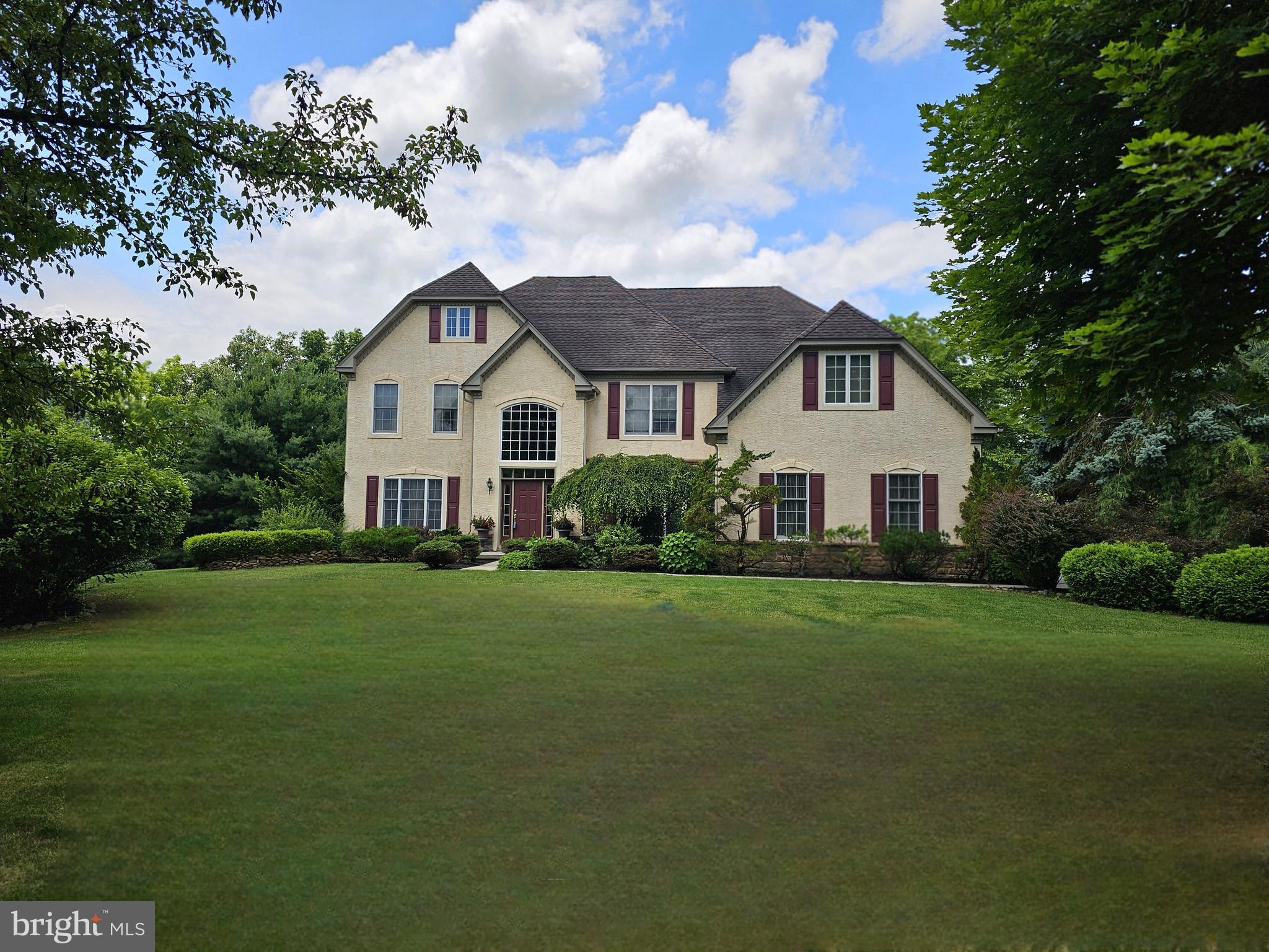 Welcome to Fox Creek Estates, one of Williams Township's most desirable communities. This stunning center hall colonial offers exceptional space, elegance, and versatility, set on beautifully landscaped grounds that provide a private and peaceful retreat. Step into the dramatic two-story foyer, where an open staircase and soaring ceiling create a remarkable first impression. The formal living and dining rooms are enhanced by custom moldings and timeless architectural details, while the spectacular two-story great room features an LPG fireplace and expansive windows that fill the home with natural light. The heart of the home is the massive gourmet kitchen, thoughtfully designed with granite countertops, a center island, desk area, walk-in pantry, and custom cream-colored cabinetry with oil-rubbed finishes. The main level also includes a charming sunroom with atrium door to the outdoor living space, a private den/office (could be a 1st- floor bedroom), convenient laundry/mudroom, and half bathroom. Upstairs, a balcony overlooks the great room below, adding to the home's open and airy feel. The luxurious primary suite is a true sanctuary, featuring a sitting/bonus room, two walk-in closets, and an exceptional spa-inspired bath with a two-sided glass shower, separate vanities, and dual toilet areas. Three additional generously sized bedrooms and two full baths complete the second floor. The fully finished lower level offers incredible flexibility for extended family living, guests, or entertaining. This space includes a granite kitchen, spacious living/recreation room with outside entrance, bedroom, modern full bath, walk-in closet, and an enormous storage area. Outside, enjoy your own backyard oasis featuring a beautiful stamped concrete patio, mature landscaping, and colorful flowering perennials that provide beauty and privacy throughout the seasons. Additional highlights include LP gas heat and hot water, central air conditioning, PEX plumbing, generator hookup capable of powering essential home systems, and a brand-new septic drainfield to be installed for added peace of mind. Ideally located with easy access to New Jersey, Riegelsville, downtown Easton, and Bethlehem, this remarkable property combines luxury, comfort, and convenience in an exceptional setting.