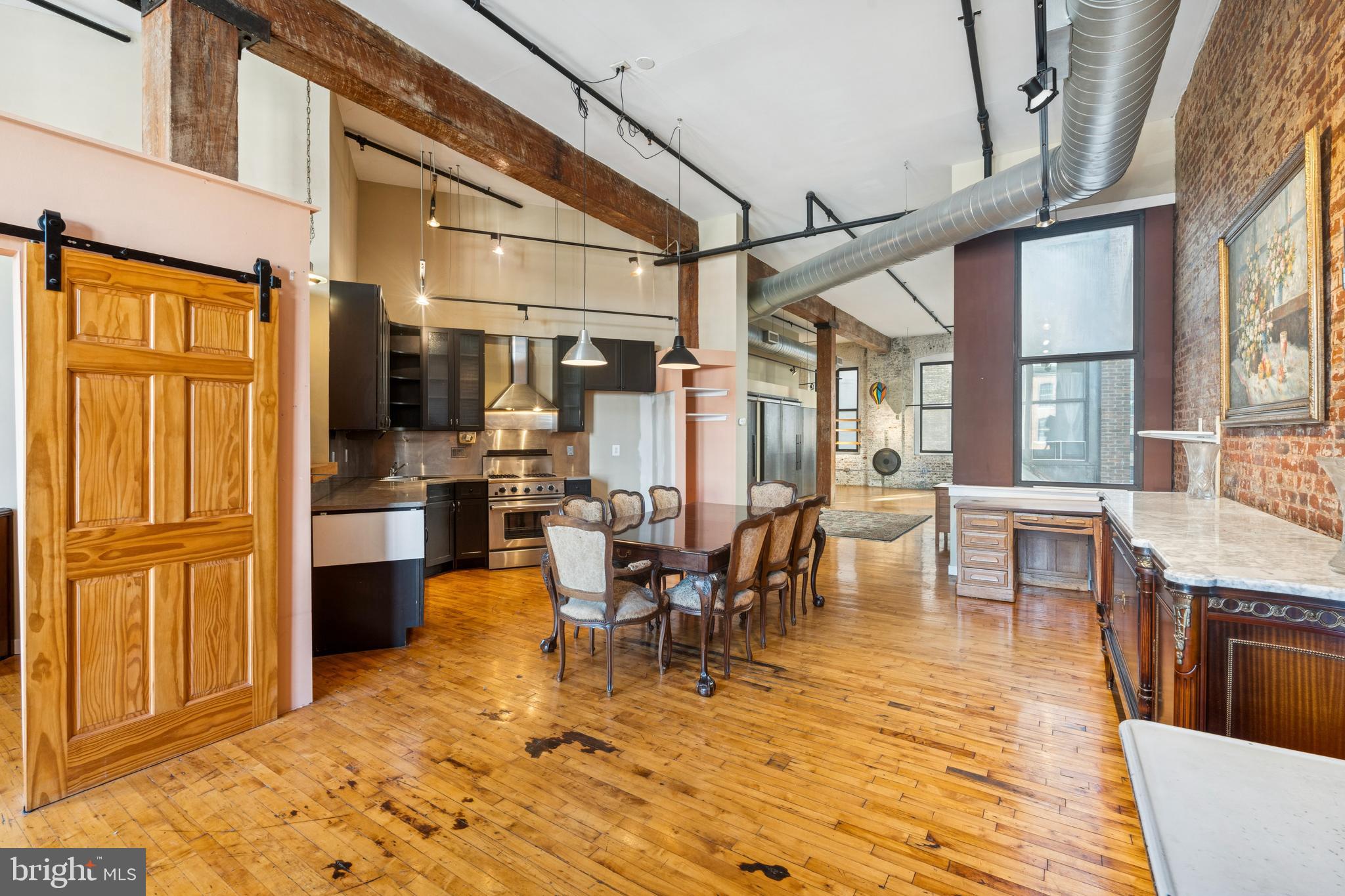 Welcome to this SOHO-style midrise loft in the sought-after Callowhill Historic District with INDOOR PARKING IN THE BUILDING available. This building is the iconic former Hat Factory, and is a converted loft building. This large and unique unit with open floor plan features 1,358 square feet of living space and tons of original architectural details, including soaring ceilings, elevated track lighting, sanded exposed beams, exposed brick, and original maple flooring with outstanding patina. Open kitchen, washer and dryer in the unit, and amazing storage space. Currently one walled bedroom, but the layout in this unit easily lends itself to being a 2 (or even 3) bedroom.

The building features a new Yoga Studio, a planned café, an Alpha Touch entry system, plus direct access to the coveted Rail Park (high line park) for an unbeatable urban convenience. The Historic Callowhill District is booming, and this location is primed for exceptional appreciation. Major city projects, including the upcoming Spring Garden Greenway and the transformative Chinatown Stitch Project, are both set to greatly increase neighborhood value. Take an easy walk to Reading Terminal Market, City Hall, the convention center, the fashion district, world-class museums, grocery stores, and the subway is right around the corner. Additionally, there are amazing bars and restaurants within walking distance. Great access to Chinatown, Spring Garden, and other center city neighborhoods and cultural centers. The newly constructed Philadelphia Ballet Center for Dance is just three blocks away. The Broad Street Subway is two blocks away for a quick ride to the Sports Complex. A few blocks from The Met, concert venue on Broad Street, Union Transfer, and Franklin Music Hall. Walkable grocery stores include Trader Joes, Aldi, Giant, and more.  This amazing unit also allows easy, walkable access to Reading Terminal Market, Cafe Lift, Prohibition Taproom, Juno, Love City Brewing, Wood Street Pizza, Starbucks, and so much more that this Philly industrial neighborhood has to offer. At the time of this listing, there are secure indoor parking spots available at the basement level of this building for a monthly fee.  Exterior renovation of the brick was fully completed in 2025. Elevator renovation and modernization project set for June 2026 (will not impact HOA fees). HOA currently evaluating installation of community roof deck project.