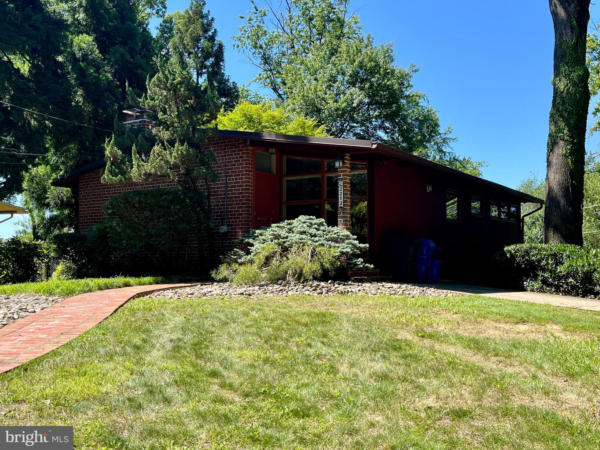 This is a beautiful Mid-Century Modern home situated on a professionally landscaped corner lot overlooking parkland. This property features a vaulted living room ceiling and floor-to-ceiling windows that provide exceptional natural light and a seamless flow throughout the home.
The main level includes a kitchen with granite countertops and bar seating that opens into a comfortable dining area. The primary bedroom offers an en-suite bath and ample closet space, while a second bedroom is serviced by a nearby hall bath.
The lower walk-out level features French doors that lead to a wonderful patio, ideal for summer entertaining. This level also includes two additional bedrooms or office spaces, a full bathroom, and an inviting recreation room.
Located just minutes from downtown Silver Spring, the Green Line Metro, and the upcoming Purple Line, this home offers convenient access to shopping, entertainment, and downtown Washington. Additionally, the Gwendolyn Coffield Community Center offers a social hall, game room, and more in its 23,000 foot facility.  The outdoor space offers a basketball court, tennis court,  playground, and great walking paths.
The home is being sold "as is," offering a perfect opportunity to add your own personal touches.