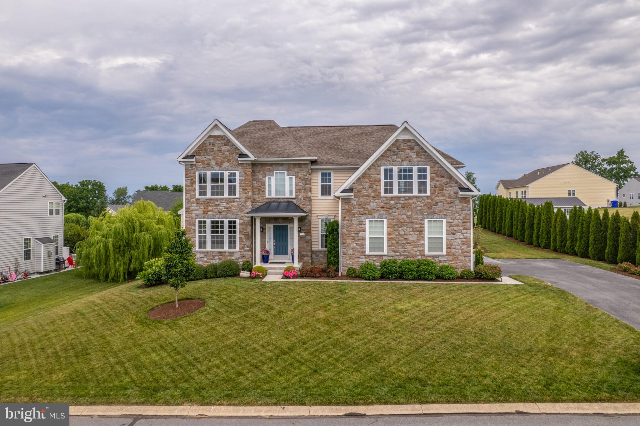 Welcome to a home where timeless elegance meets exceptional craftsmanship. From the moment you step into the impressive two-story foyer, you'll be welcomed by soaring ceilings, abundant natural light, and the unmistakable attention to detail that carries throughout this exceptional residence. A striking stone façade, beautifully manicured landscaping, and outstanding curb appeal create an unforgettable first impression.
Every detail showcases quality craftsmanship, from the rich hardwood floors and ceramic tile to the elegant crown moldings, upgraded designer light fixtures, fresh interior paint, professionally shampooed carpeting, and high-end window blinds, creating a polished, turnkey interior.
Designed for both everyday living and effortless entertaining, the thoughtfully designed floor plan features formal living and dining rooms, along with a beautifully appointed kitchen offering granite countertops, abundant cabinetry, an oversized center island, and stainless steel high-efficiency appliances. The adjoining breakfast area overlooks the backyard, while the inviting great room is centered around a warm gas fireplace, creating the perfect place to gather and unwind.
The spacious primary suite offers a peaceful retreat with a custom walk-in closet and a beautifully appointed en suite bath featuring a soaking tub, double vanity, and separate tiled shower. Generously sized secondary bedrooms provide flexibility for guests, a home office, hobbies, or additional living space.
The finished walkout basement extends the home's versatility with expansive space for recreation, a media room, fitness area, game room, or office. A separate storage room with custom built-in shelving provides exceptional organization and abundant storage.
Step outside to discover one of the home's most impressive features. The professionally designed outdoor living area showcases an expansive premium paver patio crafted with quality materials, elegant stone retaining walls, decorative pillars, and built-in seating, creating an exceptional setting for entertaining or simply enjoying the peaceful surroundings. Surrounded by mature evergreen trees that provide beautiful year-round privacy, the backyard is a tranquil retreat enhanced by professional landscaping and exceptional hardscaping.
Additional improvements include a roof replaced within the past few years, upgraded designer lighting, fresh interior paint, professionally shampooed carpeting, and numerous thoughtful updates that enhance both style and efficiency.
Beautifully blending timeless design, exceptional craftsmanship, and thoughtfully designed indoor and outdoor living spaces, this remarkable home offers the perfect balance of elegance, comfort, and everyday functionality. A home of this quality is truly one that must be experienced in person.