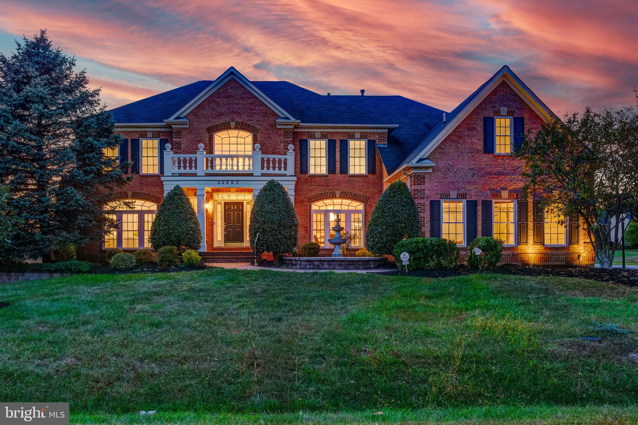 Welcome to this exquisite Colonial residence nestled on over half an acre in the highly sought-after Belle Terra community. Boasting over 8,000 square feet of luxurious living space, this 5-bedroom, 5.5-bathroom home offers timeless elegance, modern upgrades, and exceptional attention to detail throughout.

Upon entry, you are greeted by a grand two-story foyer featuring gleaming Brazilian cherry hardwood floors, dual staircases, and a stunning chandelier that sets the tone for the sophistication found within. The expansive two-story family room is ideal for entertaining, showcasing a gas fireplace, stately built-ins, and floor-to-ceiling windows that flood the space with natural light. This space also features brand-new carpeting for added comfort.

The gourmet kitchen is a chef’s dream, equipped with high-end stainless steel appliances including a Sub-Zero refrigerator, Thermador range, and Bosch dishwasher. Newly installed quartzite countertops, bright white cabinetry, and a brand-new convection microwave/wall oven combination complete this beautiful space. A light-filled morning room provides the perfect setting for casual dining, while the formal dining room and spacious living room offer elegant spaces for hosting. A private home office, main-level laundry room, and a stylish half bath complete the main level.

Upstairs, the lavish primary suite is a true retreat, featuring a sitting area, tray ceiling detail, and a luxurious en suite bathroom with dual vanities, an oversized glass shower, and a soaking tub. The impressive walk-in closet spans 20 feet, offering an abundance of space and organization. Three additional bedrooms, each with access to beautifully appointed bathrooms, complete the upper level.

The walk-out lower level is designed for entertainment and relaxation, featuring a home theater, wet bar, recreation room, and a private guest suite.

Outside, the professionally landscaped backyard provides an inviting space for outdoor gatherings and leisure. Additional highlights include a three-car garage and the unmatched convenience of living in one of Loudoun County’s most desirable communities.

This exceptional Belle Terra residence seamlessly combines luxury, comfort, and function—an extraordinary place to call home.