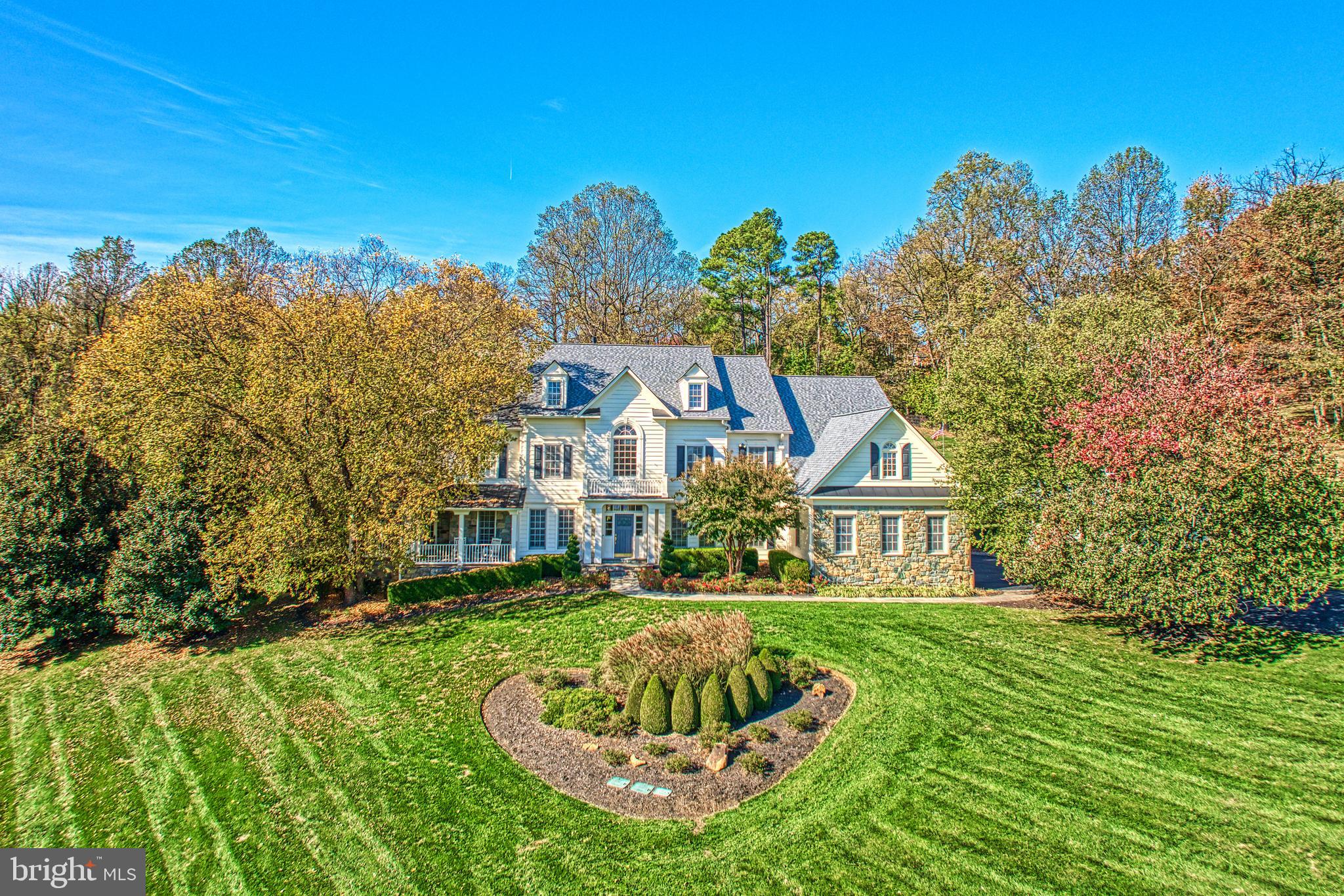 Tucked within a private cul-de-sac and embraced by sweeping acreage and mature landscape, this beautifully appointed Grand Monet residence offers an exceptional lifestyle on over four scenic acres in Beacon Hill. Designed for both effortless entertaining and everyday luxury, the home spans  almost 9,000 square feet of refined living space where natural light, elegant millwork, and thoughtful architectural detailing create an inviting sense of grandeur. At the heart of the home, the gourmet kitchen dazzles with high-end appliances, rich cabinetry, and an inviting island ideal for gathering. A vaulted ceiling sunroom frames tranquil views of the grounds, while gracious living and dining spaces flow seamlessly for hosting celebrations large and small. Each bedroom is generously scaled and features its own private bath, providing comfort and privacy for guests. The primary suite serves as a serene retreat with its own sitting room, fireplace, and spa-inspired bath, a sanctuary for morning coffee or winding down at day’s end. Outdoors, the spectacular backyard has been transformed into a private resort, complete with a custom pool and spa, cascading waterfall, fire pit, layered stone hardscaping, lush lawns, and a cabana—an unforgettable setting for summer soirées, autumn evenings by the fire, or quiet mornings under the trees. The finished lower level is designed for both recreation and relaxation, featuring a custom speakeasy-style bar, expansive lounge area, full bath, bonus room, and dedicated workout room. A rare offering combining privacy, sophistication, and true resort-style living within minutes of historic Leesburg, boutique shopping, restaurants, vineyards, golf, and the beauty of Virginia Hunt Country.

New Roof, updated  hvacs, hot water heater, well pump and more!