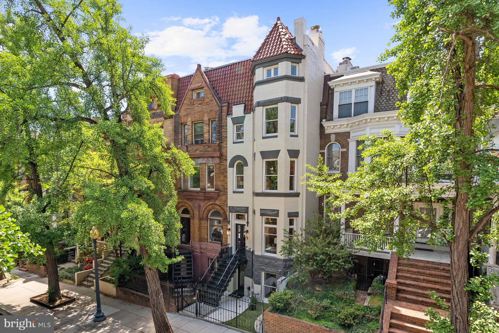 NEW PRICE! Experience the pinnacle of refined living in this newly reimagined architectural residence by William Andrew Homes. Ideally positioned along a one way, tree-lined street, and located in the sought-after Oyster-Adams school district, this extraordinary residence boasts 6 Bedrooms, 6.5 Bathrooms and approximately 5,071 square feet across 5 stories of impeccably finished living space. A true masterpiece, every detail has been meticulously crafted from the hand-picked Dekton stone selections, timeless Family Legacy Collection herringbone floors, designer lighting, the Artisan handmade staircase railings and balusters, custom curved doors, and bespoke millwork trim package that carries gracefully throughout the home. The main level unfolds with elegant Living and Dining rooms anchored by two of four wood-burning fireplaces, each appointed with custom Dekton stone mantels. At its heart, the gourmet Kitchen is a true showpiece–featuring custom-milled cabinetry by Studio37 Cabinetry, striking Dekton stone countertops, premier Wolf and Sub-Zero appliance package, and gorgeous glass enclosed wine cellar. Enjoy a convenient family room flowing effortlessly off the Kitchen for refined everyday living and entertaining. The grand architectural staircase, crafted by Century Stair Company, spans all four upper levels and showcases custom railings and balusters, serving as a sculptural focal point of the residence. Upper Level 1 is dedicated entirely to the luxurious Primary Suite–a private sanctuary complete with a spacious Bedroom adorned with specially imported designer wallcoverings, a lovely fireplace, expansive dressing suite, spa-inspired Bathroom, and private Balcony. Additional Upper Levels offer 3 generously scaled Bedrooms and thoughtfully designed Bathrooms, and a top-floor Sitting Room with floor-to-ceiling sliding glass doors that unveil a show-stopping Rooftop Terrace with panoramic city and monument views of Washington, DC. Multiple outdoor spaces–including 3 private decks and terraces feature Trex decking and custom metal railings–provide seamless indoor-outdoor living. This impressive residence is complete with 2 car secure parking with EV charger, 8 in-ceiling Sonos speakers, top-of-the-line security package with custom-fabricated metal front gate, secure roll-up garage door, high-tech Brivo security keypad and Ring video doorbell systems and is finished with premium HVAC systems to provide consistent comfort across all levels. The fully finished Lower Level offers exceptional flexibility as a private guest retreat or income-producing opportunity. With 2 Bedrooms, 2 full Bathrooms, a full-size Kitchen with Dekton countertops and stainless-steel appliances, dedicated smart Washer/Dryer, and both front and rear entrances, the space conveys with a certificate of occupancy for added versatility. With meticulous attention to detail and no expense spared, this showpiece residence is sculpted to perfection, seamlessly blending timeless architecture, modern luxury, and thoughtful functionality in one of Washington’s most prestigious neighborhoods.