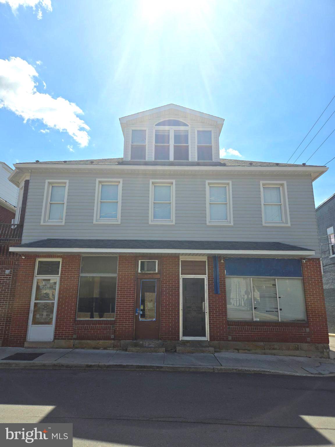 Rare opportunity to own an entire half block of Frostburg history in the Historic District. Comprising 8, 10, and 12 South Broadway, this unique mixed-use property offers exceptional potential for investors, entrepreneurs, and owner-occupants alike.

For more than 50 years, this building was home to a beloved local bakery, and now it's ready for its next chapter.

8 S. Broadway provides access to the spacious residential living quarters featuring a living room, dining room, kitchen, den, 2 bedrooms, and 1.5 baths. The den could easily serve as a third bedroom, home office, or flex space.

10 S. Broadway was formerly the bakery's retail storefront. This space includes a half bath and a former cake room that could be converted into a galley kitchen, creating the potential for an additional rental unit or expanded commercial use.

12 S. Broadway housed the bakery operations. All equipment has been removed, leaving a blank canvas for your vision. Plumbing connections remain in place for future sink and bath fixtures, making this space ideal for a new business, studio, office, retail venture, or efficiency apartment conversion.

The commercial portion benefits from an existing fire suppression system and utility hookups suitable for many food and beverage operations, while also offering flexibility for retail, office, service-based businesses, and more.

The residential space features beautiful hardwood floors, a bright bay window, abundant natural light, cedar closets, convenient laundry, a half-bath ensuite, and an expansive third-floor loft that offers even more living or storage space.

Whether you're looking to open a business, create multiple income-producing units, or live where you work, this property presents a unique opportunity in a thriving downtown location surrounded by established businesses and just steps from Main Street.

Property is being sold AS-IS. Remaining equipment will be removed prior to closing. Schedule your showing today and bring your vision to life!