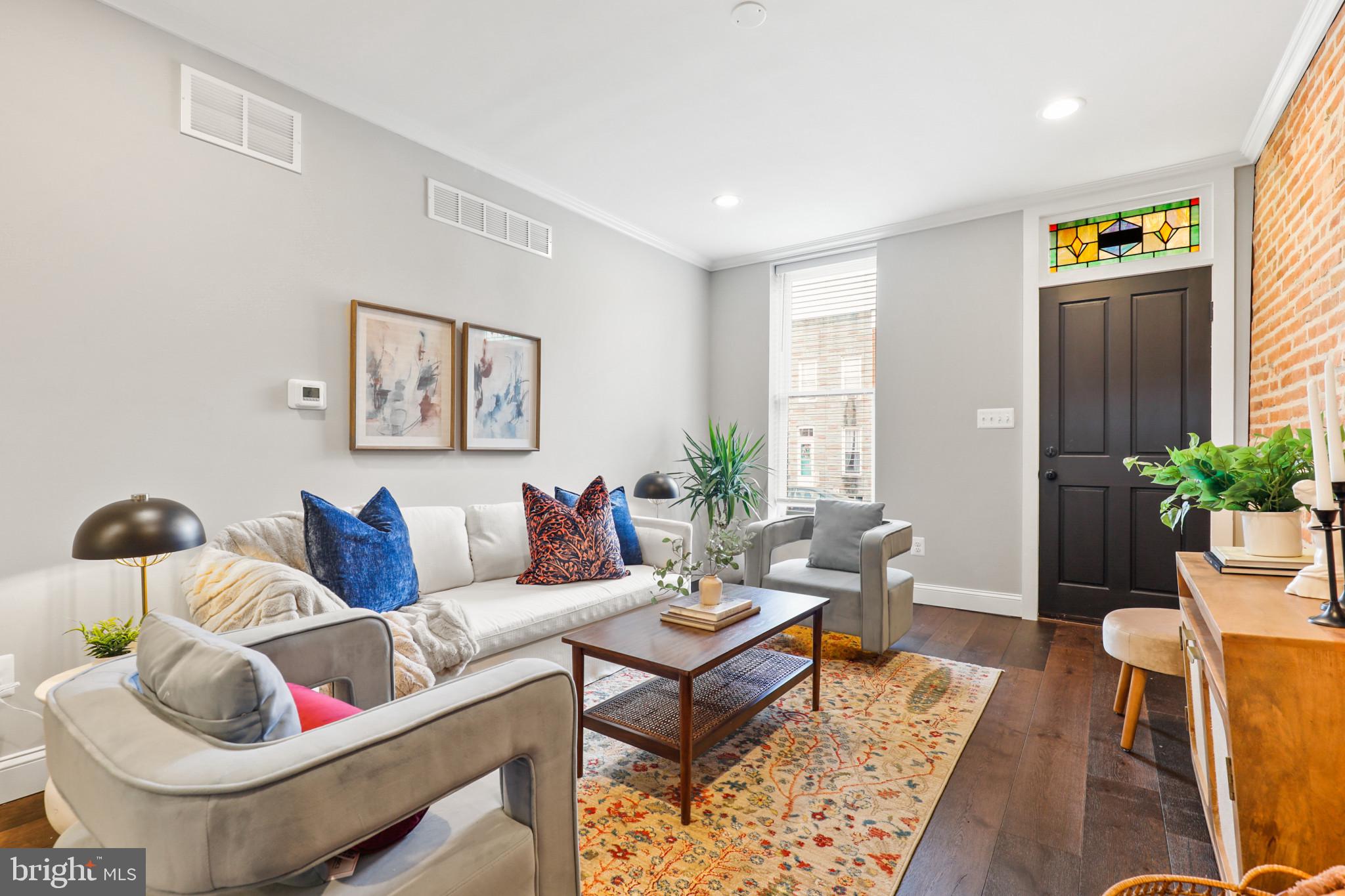 Nestled in the vibrant Locust Point neighborhood, this exquisite 4-bedroom, 3-bathroom townhouse offers a harmonious blend of historical charm and modern luxury. Built in 1875, the home resonates with Baltimore's rich history, while its recent updates provide all the comforts of contemporary living.

As you step inside, the warm embrace of natural wood flooring and recessed lighting welcomes you. The gourmet kitchen, a chef's delight, features stainless steel appliances, elegant countertops, and a convenient breakfast area. The open floorplan, accentuated by crown molding and built-in features, creates a seamless flow for entertaining and daily life. The home's thoughtful design extends to the finished basement, boasting a generous 440 sqft of additional living space, perfect for a family room or home office.

Upstairs, the bedrooms offer serene retreats, each with ample space and natural light. The primary suite features a luxurious bath, ensuring a private and peaceful haven. Additional amenities include energy-efficient appliances, a central air conditioning system, and a cozy backyard for outdoor relaxation.

This townhouse is a rare gem in Baltimore City, offering the convenience of off-street parking – a prized feature in the urban landscape. The property's brick construction not only adds to its aesthetic appeal but also stands as a testament to its sturdy and enduring nature.

Discover the perfect blend of historical elegance and modern comfort at 1410 Hull St – a home that promises a lifestyle of convenience, style, and tranquility in the heart of Baltimore.