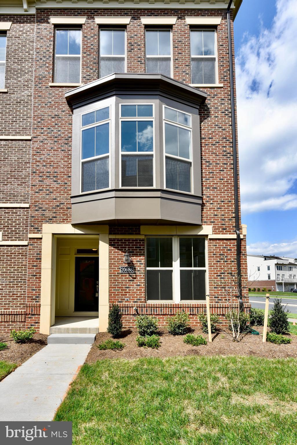 Only 5 years old, MILLER & SMITH HOME IN ONE LOUDOUN! 2,529 sq. ft. of living space in an open light-filled floorplan. Quality is evident from your first glance at the architectural details of this contemporary townhome with brick front. Once inside, the first level greets you with 9 ft. ceilings, a roomy foyer, storage room, full bath with shower and family foyer with large closet. Hardwood stairs lead to the main living level which opens up with spectacular 10 ft. ceilings, a gorgeous kitchen with quartz counters, white shaker cabinets, Samsung appliances including 36” cooktop, SS Hood, French Door Fridge and built-in oven & microwave. The huge contemporary island has black cabinets and pendant lighting; walk-in pantry features wood shelves. A stunning dining room showcases tray ceiling and bay window. The private powder room is tucked around the corner, and the impressive entertaining room includes ceiling beams and gas fireplace that opens to a partially covered terrace! A spacious owner’s suite with tray ceiling includes a large walk-in closet with window and a spa-like bathroom that showcases an oversize shower with rain showerhead and full-length seat. Two additional bedrooms, hall bath and laundry room complete the upper level. Enhanced Vinyl Plank flooring throughout 1st two levels & 3rd level hallway; upgraded carpet in all bedrooms. Ideally located at Route 7 & Loudoun County Parkway, living in One Loudoun allows you to enjoy the luxury of having a variety of conveniences, amenities and excitement right at your fingertips. From endless dining options to events nearly every weekend on the plaza or at The Barn, it’s where Loudoun County goes for FUN. If a slower pace is more your style, then One Loudoun’s Central Park offers acres of natural beauty filled with trails, benches and quiet areas. Prefer athletic adventures? The Club at One Loudoun provides a resort style pool with snack bar, 2 tennis courts, a multi-purpose court and large entertaining room and catering kitchen.