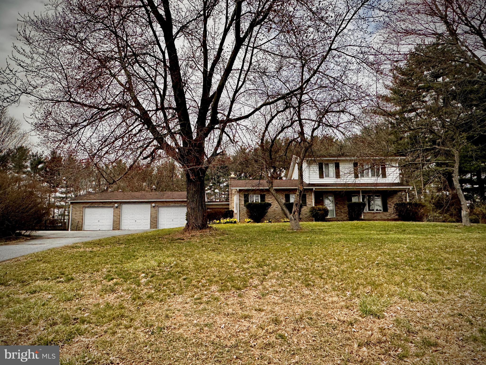 PLEASE DO NOT visit the property or walk around the property without a scheduled appointment accompanied by an agent! Nestled on a picturesque 2.7-acre lot in the Winfield area of Southern Carroll County, this 3-bedroom, 2.5-bath Colonial offers endless potential. A true blank canvas, this home is ready for your updated and creative touch and is being sold AS IS—a fantastic opportunity for investors, contractors, or homeowners looking to build equity. 
The covered front porch welcomes you into the main level, featuring a foyer, powder room, formal dining room, and a spacious kitchen with ample cabinetry and counter space. The bright and airy great room boasts large windows, a fireplace with a wood stove insert, and a sliding glass door leading to the three-season Florida room overlooking the private backyard.
Upstairs, you'll find a primary suite with a private bath and shower, plus two additional bedrooms with generous closet space and a shared hall bath. The lower level includes a family room, an entertainer’s bar area, storage closets, a laundry/utility room, and a walk-out stairwell to the backyard.
Recent updates include a Rheem Heat Pump/CAC installed in September 2023. A spacious breezeway connects the Florida Room to a 1,000+ sq. ft. detached 3-bay garage, complete with a 13' x 14' storage room—ideal for car enthusiasts, collectors, or hobbyists.
The private rear yard features an in-ground pool (in need of restoration) and a pool house, offering a great space for relaxation and entertaining.
The list price reflects the property’s current condition—don’t miss this chance to transform this home into your dream residence or investment opportunity!