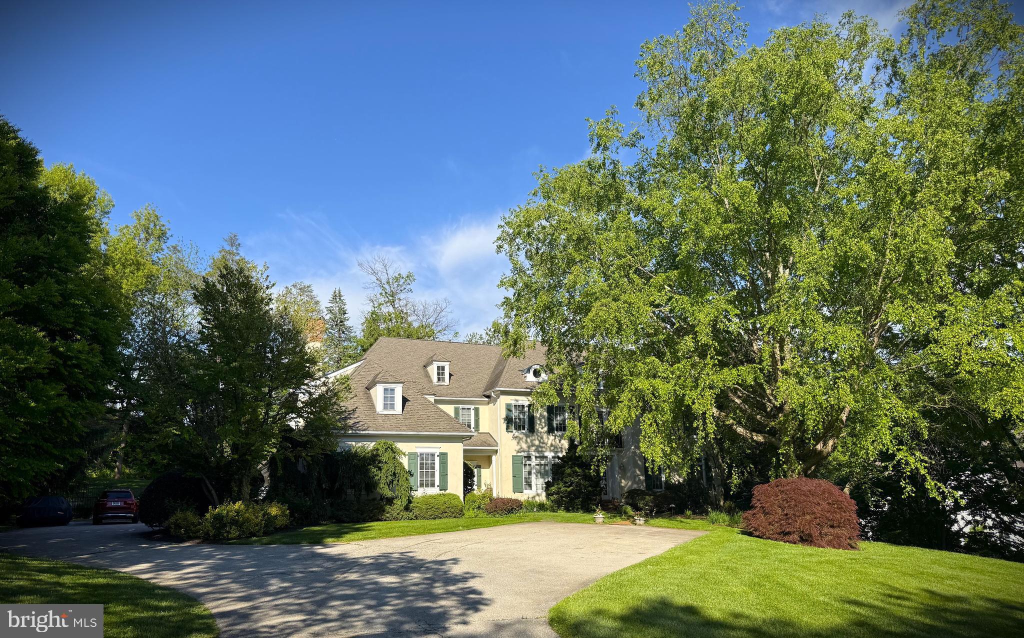 Nestled on a beautifully landscaped 0.79-acre lot in the sought-after Harriton Farm neighborhood of Villanova, this elegant center hall Colonial offers 5 bedrooms, 4 full bathrooms, and 2 half bathrooms with exceptional indoor and outdoor living spaces. A heated inground pebble pool with jacuzzi/hot tub and expansive flagstone patio create a private backyard retreat perfect for relaxing or entertaining while enjoying the serene surroundings. A grand entry with open staircase and large windows welcomes you into the home, where beautiful hardwood floors and exquisite architectural detailing flow throughout the first floor. The formal living room with crown molding and wood burning fireplace opens seamlessly to a richly appointed office/den with dark wood finishes.  The formal dining room with crown molding provides the ideal setting for hosting dinner parties both grand and intimate.  A charming Country Craft bar and service area connects the dining room to the spacious chef’s kitchen featuring Country Craft Cabinets, a large center island with gas cooktop, double wall ovens, stainless steel appliances, built-in desk area, and a sunny breakfast room overlooking the picturesque backyard. The kitchen flows effortlessly into the bright and inviting family room with a wood-burning fireplace, abundant natural light, and tranquil backyard views. Two convenient half bathrooms complete the main level, including one located off the mudroom with access to the impressive, built-in 4-car garage. The second floor features a luxurious primary bedroom suite with a fireplace, a separate sitting room, two walk-in closets, and a spacious en-suite bathroom with a soaking tub. A second bedroom offers private access to a full hall bathroom, while two additional bedrooms share a Jack and Jill bathroom. Convenient second-floor laundry.  Expansive flex space offering endless possibilities for a media room, fitness studio, playroom, or executive office completes this level. The finished lower level provides incredible versatility with a large recreation/playroom, additional bedroom, full bath, and outside entrance, making it ideal for an au pair suite, guest quarters, or extended family living. Located in the award-winning Lower Merion School District on a quiet cul-de-sac and just minutes from major roadways, shopping, dining, and Center City Philadelphia, this exceptional home combines timeless elegance with modern comfort in one of the Main Line’s most desirable neighborhoods.