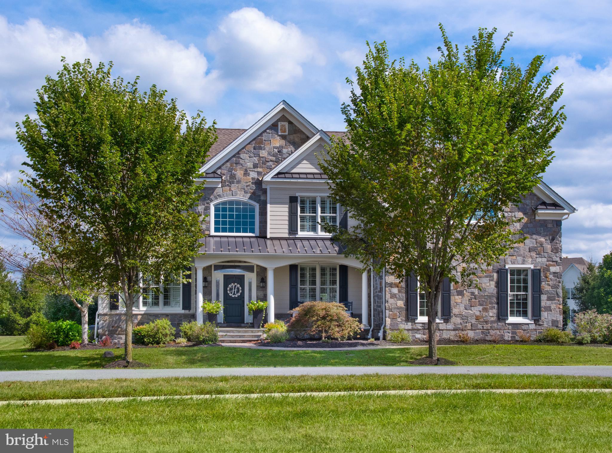 Welcome to 307 Green Bank Lane in the sought-after community of Liseter. This expanded Duke model was built with nearly every structural upgrade, offering thoughtful spaces for both everyday living and entertaining.

Step inside to a bright two-story foyer with a sweeping staircase. To the right is the dining room, perfect for holidays and gatherings, while to the left sits a living room that can also serve as a home office or study. At the heart of the home, the two-story family room with fireplace opens into a gourmet kitchen and additional flex spaces. Just off the family room is a sun-filled playroom (ideal as a second office or homework space) and a sunroom that walks out to the deck for easy indoor-outdoor living.

The kitchen is designed for both style and function, anchored by an oversized island large enough for seating, prep, and serving. Outfitted with top-tier appliances, it features a gas range top, double wall oven, and a built-in Sub-Zero refrigerator, along with quartz countertops, custom cabinetry, and designer lighting — making it a true centerpiece for gatherings. A well-sized laundry room and separate mudroom with built-ins add everyday convenience.

Upstairs, the primary suite feels like a retreat with a double-door entry, a spacious sitting room, and a tray ceiling. A dedicated vanity area leads to the spa-like bathroom, which features two separate vanities, a soaking tub, and a large glass-enclosed shower. Two bright bedrooms share a full bath, while the fourth bedroom offers the privacy of its own en-suite.

Outdoors, this home invites you to relax on the front porch overlooking a charming pocket park just across the street. The property sits on almost an acre, providing a sizable, flat backyard with private backing — perfect for play, gardening, or quiet relaxation. The expansive deck creates multiple areas for entertaining, from outdoor dining to cozy lounge setups. Curb appeal is elevated with upgraded Hardie board siding and real cut stone, blending timeless architecture with low-maintenance durability.

Liseter residents enjoy access to a clubhouse, pool, fitness center, walking trails, and pocket parks — all just minutes from shopping, dining, top-rated schools, and major commuter routes.

307 Green Bank Lane combines nearly every structural upgrade with a premier lot and high-end finishes, making it one of the most desirable homes in Liseter.