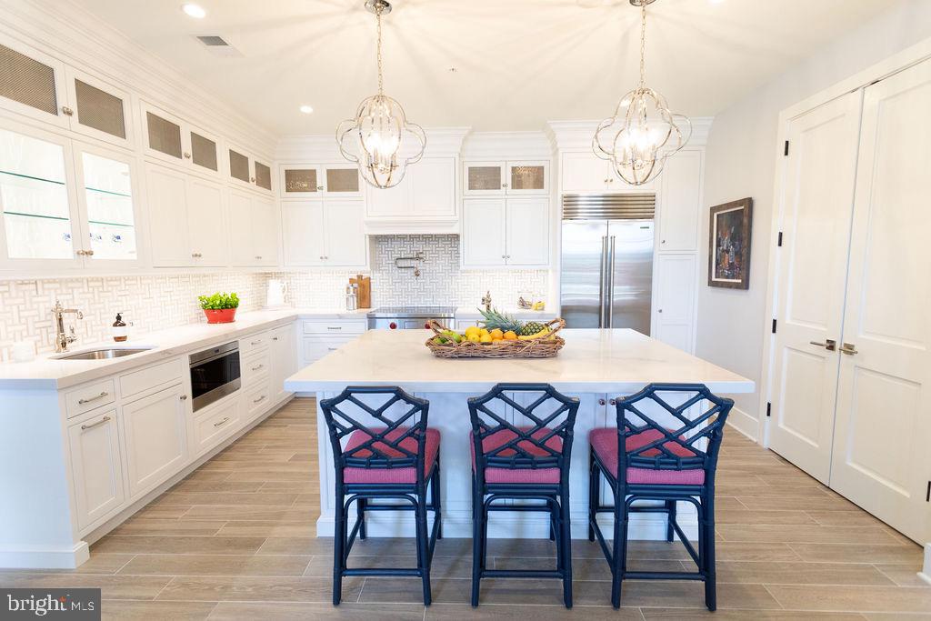 FULLY FURNISHED & TURN KEY!! The perfect home for entertaining family and friends and one of the finest Luxury condominiums located in the heart of downtown Annapolis. Designed by an award-winning Annapolis architecture firm, Hammond Wilson and featured in the Annapolis Home Magazine, this beautiful, 2,325 square ft condo features  High-end finishes throughout, an open floor plan, 9ft+ ceilings, heated floors, gourmet kitchen including Wolf & Sub-Zero appliances, quartz countertops, spa-style baths, and large windows offering plenty of bright natural light throughout.   This custom ground-floor home includes 2 PRIME deeded parking spaces in a private secure garage, a vast 400 sq. ft. brick patio on Compromise Street with plenty of room for entertaining, incredible views, and located just steps away from City Dock, Spa Creek, the Annapolis Yacht Club, Fleet Reserve, The United States Naval Academy, and all that the Historic Annapolis has to offer! 
THIS BEAUTIFUL HOME IS A MUST SEE!