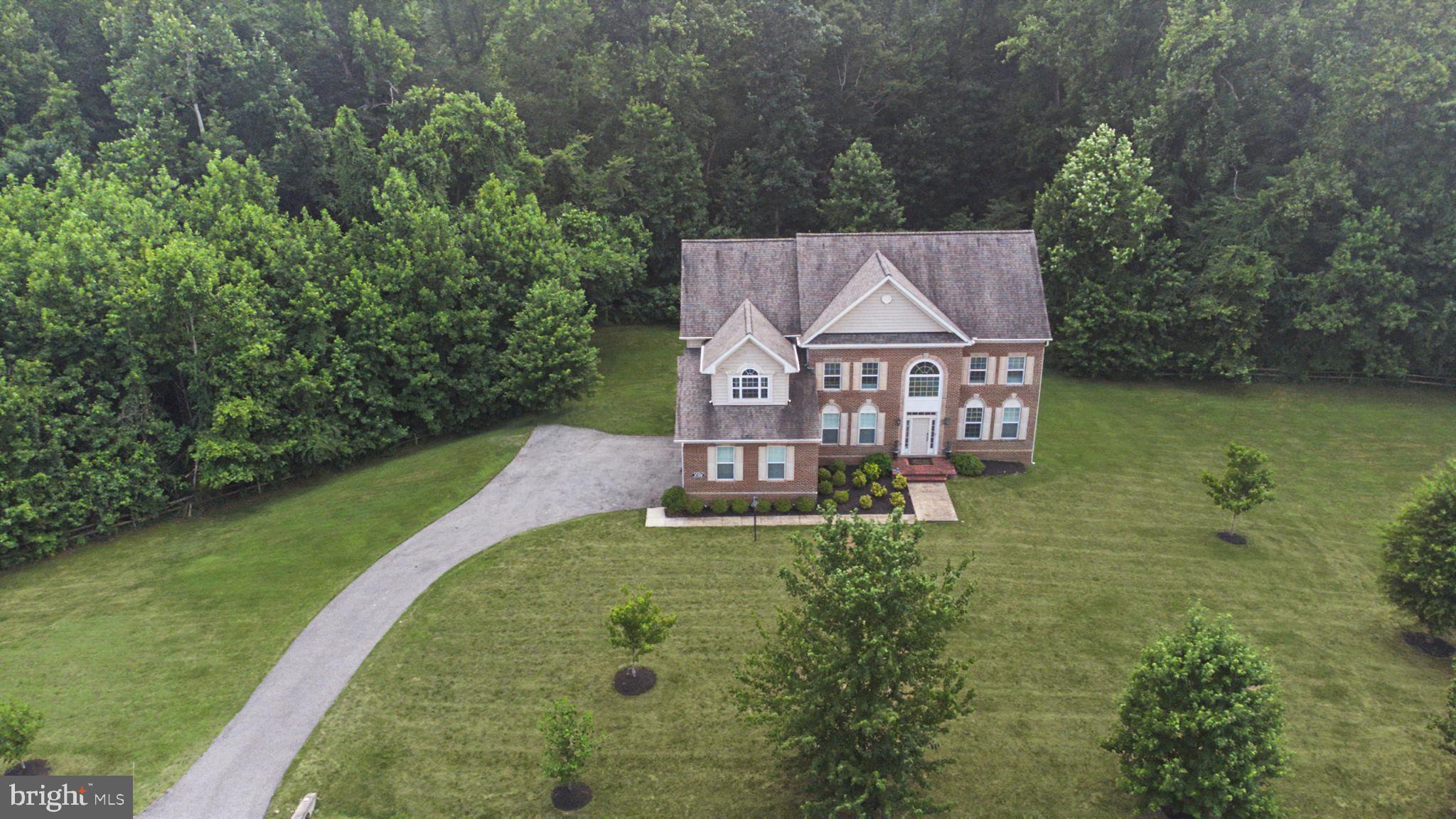 The wait is over...Welcome to 2700 Weary Creek Ct, an extraordinary Mill Branch Estates residence offering luxury, privacy, and unmatched space in the heart of Bowie. Set on 6.8 acres and boasting over 6,000 total square feet, this 2017 colonial delivers the perfect blend of elegance, comfort, and modern convenience.

Step inside to soaring spaces, abundant natural light, and high-end finishes throughout. The main level features generous formal and casual living areas, full bath, a beautiful chef’s kitchen, and seamless flow for entertaining. Upstairs you will find 4 spacious bedrooms and 3 full baths, including a serene owner’s suite with 3-sided fireplace, this home provides room for everyone. The fully finished walkout lower level offers even more lifestyle flexibility—ideal for recreation, multi-generational living, or hosting guests. Think game night, movie marathons, or home gym. Rounding out the package is a 3-car side entry garage, EV charger, and a long-paved driveway that enhances the estate like feel.

Outside, the expansive acreage offers endless possibilities: future pool, outdoor living spaces, gardens, or simply enjoying the peace and privacy of your own retreat. This property gives you the canvas to be creative. Take advantage of this rare opportunity to own a grand, meticulously maintained estate in one of Bowie’s most desirable communities. 2700 Weary Creek fells less like a house and more like a private oasis. Make an appointment today!