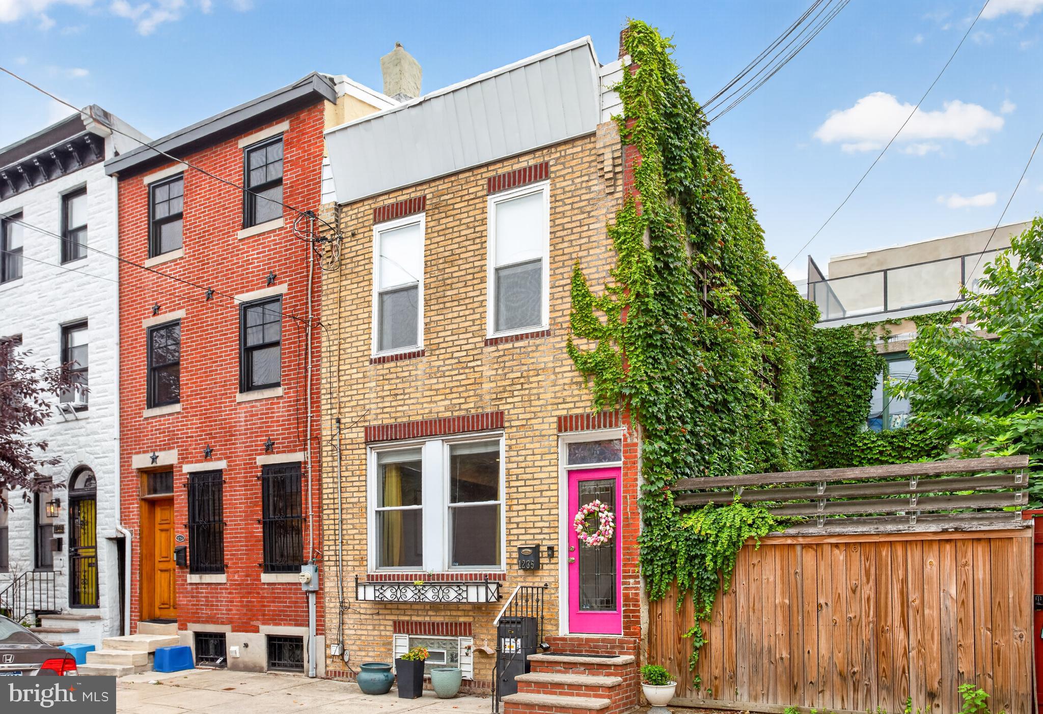 Welcome to 1235 S. 3rd Street, a charming 2-bedroom, 1-bathroom rowhome in South Philadelphia offering character, comfortable living space, and an ideal walkable location. As you approach the home, you are greeted by a beautiful front entrance accented by a decorative floral stained glass window applique  above the vibrant pink front door. Step inside through the vestibule and into the inviting living room, where hardwood floors span throughout most of the home and two bright front windows fill the space with natural light. Just beyond the living room, the dining room provides a comfortable space for everyday meals or entertaining, with direct access to the back patio for easy access to the HVAC system. The kitchen features tile flooring, granite countertops, stainless steel appliances, and a functional layout for everyday convenience. Upstairs, the first bedroom features a ceiling fan with light and works perfectly as the primary bedroom, complete with a full wall of closet space for ample clothing, shoes, and other storage. The full bathroom offers tile flooring, a partial tile wall, a step-in shower, a spacious soaking tub, and a double sink vanity. The second bedroom provides flexible space for a guest room, home office, or additional living area. The finished lower level adds even more usable space with tile flooring, a front-load washer and dryer, and a closet for storage. Recent improvements provide added peace of mind, including a new HVAC system, electric panel and service, hot water heater, sewer line replacements, gas line/meter repairs, chimney masonry repairs, new dryer vent, and a new roof that was later reflashed and coated. The home also features new kitchen flooring, along with a new bathroom floor and vanity completed in June 2026. Conveniently located in a highly walkable South Philadelphia location, this home is close to local shops, cafes, restaurants, and everyday amenities. A brand-new Trader Joe’s is also planned just about a 10-minute walk from your front door. With quick and convenient access to I-95, commuting throughout the city and surrounding areas is simple. Don’t miss the opportunity to make 1235 S. 3rd Street your next home.