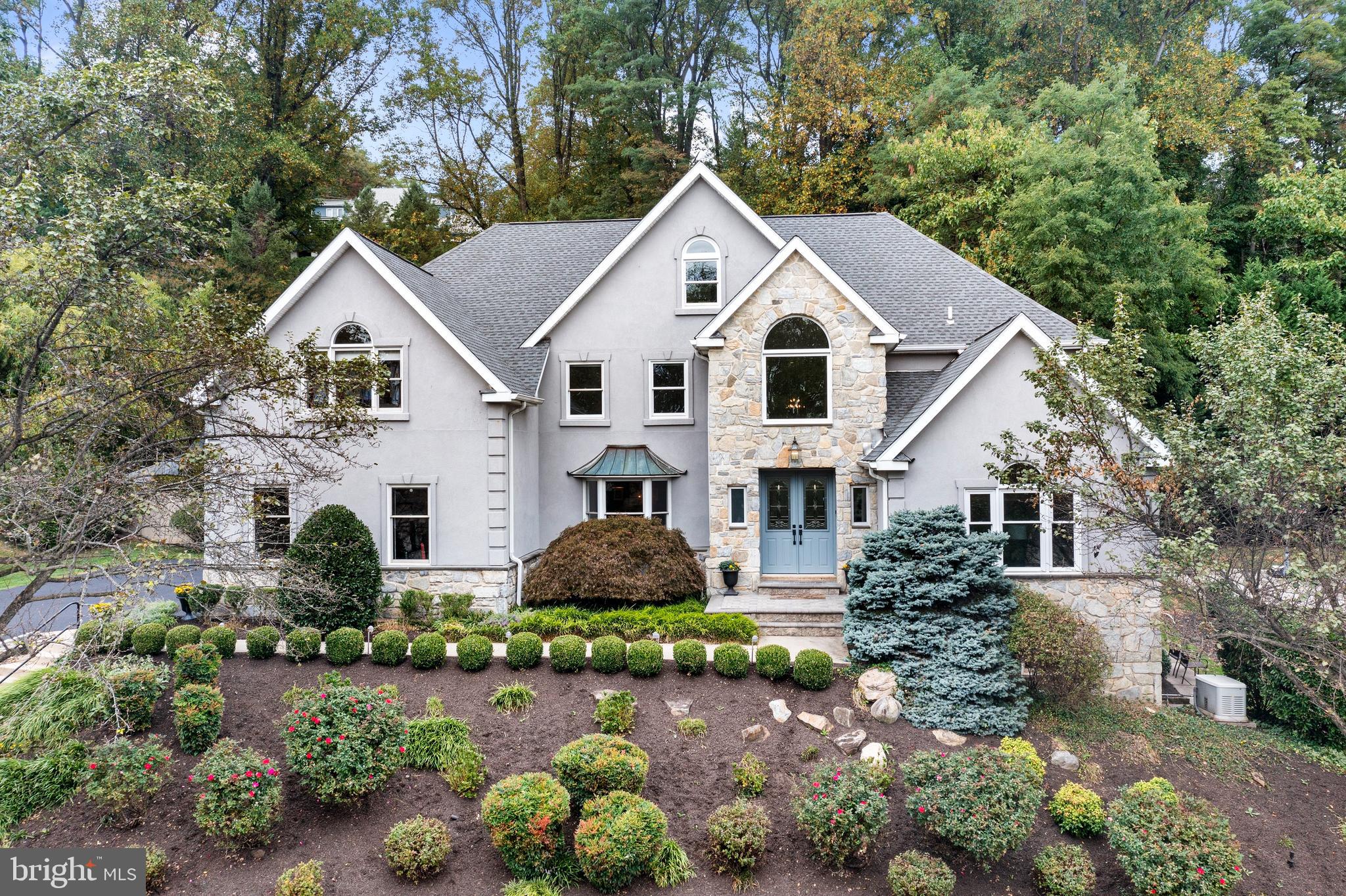 Welcome to this breathtaking, sun drenched five/six bedroom and four plus two half bath home in quiet and bucolic area of Wayne, where elegance meets functionality. As you step through the front doors you are greeted by a soaring 2-story entrance foyer​ with an oversized window that floods the freshly painted space with natural light. A spacious formal living room with cathedral ceilings to the right and a formal dining room with wainscoting, crown molding and bay window to the left flank the grand foyer. For those working from home, the main floor offers a private home office, complete with double doors, built-in shelves and recessed lighting. Continue to the sunlit gourmet, eat-in kitchen complete with floor to ceiling cabinets, updated lighting, granite countertop center island with extra seating, a stainless steel gas range and oven, ​an additional double wall oven​ and a large walk-in pantry. These are just few of the elements which make this "heart of the home" kitchen ideal for large gatherings! Step just outside of the kitchen through the large sliding glass doors to a stunning in-ground gunite pool with a separate hot tub and a lush private yard. The fully fenced yard ensures both serenity and security, making it ideal for entertaining or quiet relaxation. An open concept design allows for a perfectly situated, spacious family room with an impressive double story stone mantel gas fireplace​, 10-foot+ ceilings, ​and 3 walls of windows creating the perfect space for cozy nights at home. The main floor also includes an oversized laundry room and mudroom with extra storage, access to the attached 3-car garage​ and a separate entrance to/from the backyard​ directly. Two powder rooms are thoughtfully located on this level. A main staircase in the grand foyer and a private back staircase off the kitchen/family room area take you upstairs to the second level to the primary suite where you will find a true retreat space, featuring two oversized walk-in closets, one with a stunning eyebrow window and an exquisite primary ensuite bathroom that offers a luxurious jet tub, a steam shower, and double sinks. A true spa-like experience at home! This level also includes a full hall bathroom and three additional big bedrooms, one of which features a spacious en-suite bathroom with a tub, large vanity and large closet.​ The lower level adds 1279 sq ft to the home's 5005 sq ft totaling over 6200 sq ft of functional space. The finished lower level has separate walk-out access and a fifth bedroom and full bath, a dedicated gym space, plenty of storage and a large open area perfect for watching Eagles games on the projector screen or hosting a popcorn and movie sleepover night.​  Last but not least, the fully finished third-floor offers incredible flexibility via recreational area or sixth bedroom/au pair suite and bright finished space with a ​large walk-in closet and a separate office nook​. Located in the highly sought-after Wayne area, this home is just moments from all that Radnor and downtown Wayne have to offer, including top restaurants ​such as Amada, Estia, Goat's Beard, as well as convenient food shopping at Genuardi's​. Outdoor enthusiasts will love the proximity to area walking trail​s and Villanova University​ campus. With low taxes and highly-rated Upper Merion School District, ​the Radnor SEPTA train station just 1.5 miles away​ and easy access to all of the ​area's private schools, this home is a dream come true​. Stucco remediation completed in 2015, new roof in 2019,  a home generator, updated recessed lighting throughout, complete home sound system,  and freshly painted interior are just a few of the many elements which make this home a turn-key; It is everything you’ve been dreaming of in a Main Line Dream House!