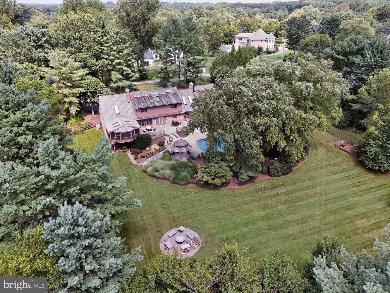 Welcome to your private retreat in the heart of Potomac. Set on a magnificent 2.01-acre lot in a
very private setting, this brick residence offers approximately 10,000 square feet across three
levels, with 5 bedrooms, 6 full and 2 half baths, and a sparkling salt water pool with hot tub set on a large terrace overlooking a sprawling lawn with lovely trees and landscaping. 

A circular drive leads to an inviting two-story entry foyer, opening to a main level offering a sumptuous primary bedroom suite with fireplace. The large living room with fireplace opens to the backyard, while a family room with fireplace and soaring two-story ceiling offers a second dramatic gathering space. The formal dining room impresses with generous moldings and custom cabinetry, and the kitchen features a large center island, upscale appliances, sunny table space, and opens to the terrace.  A large professional office space with private entrance,  fireplace, built-ins  plus a screened porch overlooking the sprawling lawn, patio, and pool, round out the main level. An oversized 4-car garage is attached to the house.

Upstairs, two distinct levels offer flexibility: an au pair/guest suite with private outside access, and a
second level with three spacious bedrooms and two full baths. The fully finished lower level offers a walkout entrance, a recreation room with bar, exercise room, carpeted entertainment area, dark room and large storage spaces.

Outside, the large sparkling salt water pool and hot tub surrounded by a flagstone terrace, is supported by a propane tank. The lush grounds create a resort-like escape.

The house is refurbished, in very good condition and sold as is as part of an estate. The cedar shingle roof and all 10 skylights were replaced in 2021. There are 4 zones of HVAC . New appliances include the cooktop and dishwasher. An equestrian easement applies to the very rear part of the yard. Safes and wine racks in basement convey. Garage conveys free of any items.

Enviably located close to Potomac Village and top-rated public and private schools — this is Potomac living at its finest, and a listing not to be missed!