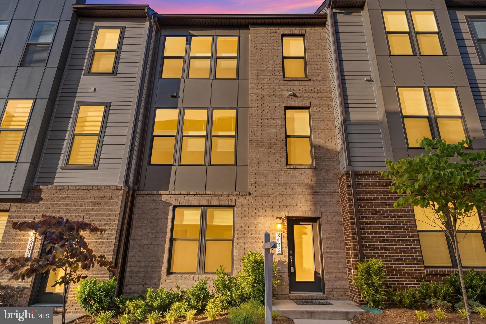 Priced Below Recent Comparable Sales.  Don't Miss this one.  Motivated Seller asks you to take a fresh new look at this stunning brick front 3-bedroom, 2 full and 2 half bath townhome built by Stanley Martin, less than 4 years young and meticulously upgraded throughout. Featuring 10-foot ceilings and Chesapeake All-American laminate flooring in Century Oak on all three levels, this home offers a modern, cohesive feel. Abundant natural light pours in through oversized 7-foot windows, all fitted with cordless top-down/bottom-up honeycomb shades.

The entry level welcomes you with a spacious recreation room, convenient half bath, and access to the 2-car garage complete with an epoxy flake floor—both durable and stylish, and perfect for a home gym or additional workspace.

The main living level is designed for both everyday living and entertaining, featuring recessed lighting and an open layout filled with natural light. The gourmet kitchen is the centerpiece, showcasing white cabinetry, quartz countertops, stainless steel appliances, a flat surface electric cooktop, double oven, pantry, and a built-in work nook. The oversized 12-foot island comfortably seats four and includes a sink, making it ideal for gathering and conversation. The living room features a built-in electric fireplace and access to the deck, while the dining area provides the perfect setting for entertaining. A powder room completes this level.

Upstairs, you’ll find three bedrooms, including a spacious primary suite with recessed lighting and two walk-in closets. The luxurious primary bath offers double vanities, a private water closet, and an oversized shower. A full hall bath and full-size washer and dryer with additional shelving add convenience. Don't miss the ease of parking in the 2 car garage.  

Location truly sets this home apart—just minutes to the Innovation Center Metro, Dulles Airport, shopping, dining, grocery stores, and Dulles South Recreation & Community Center.