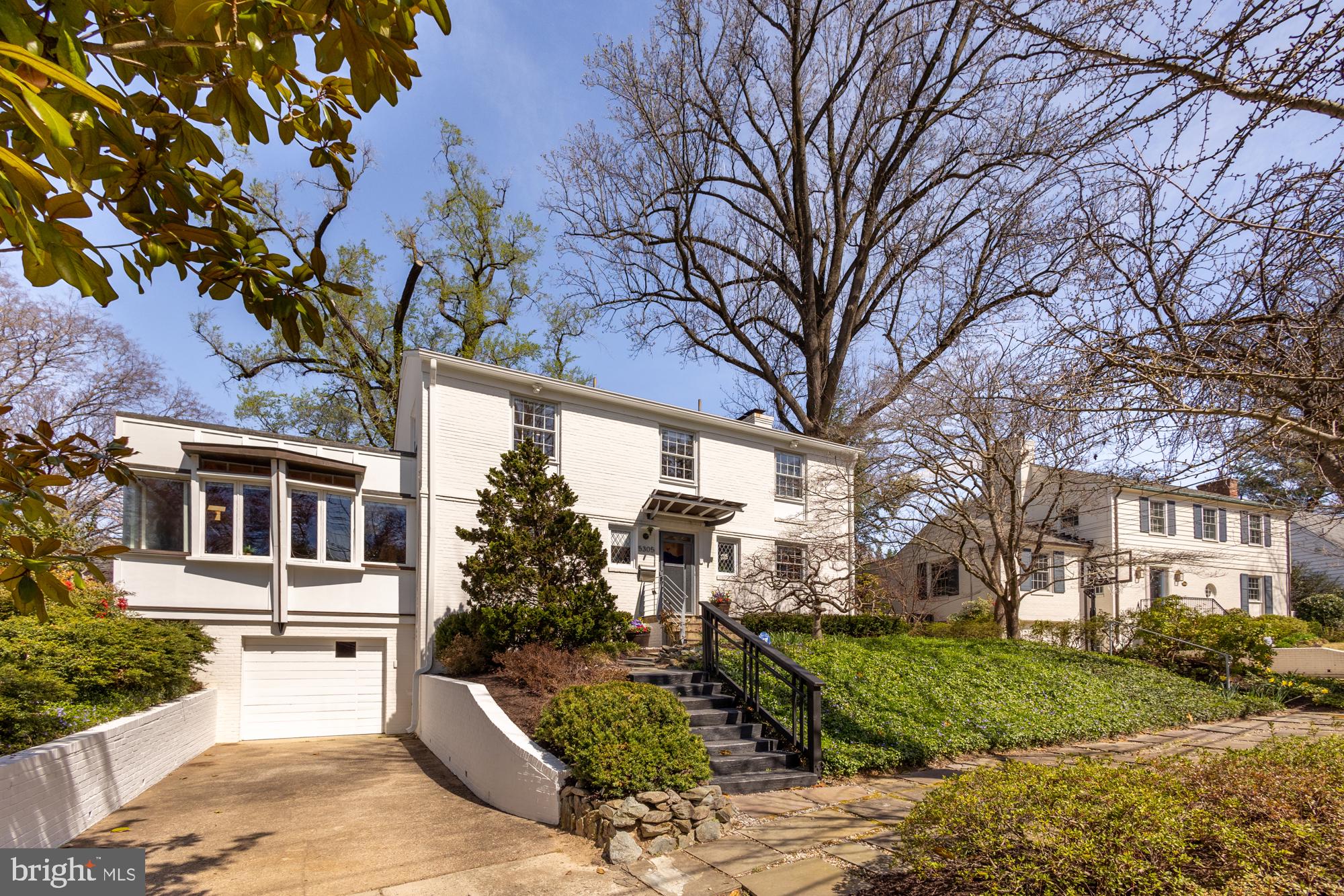 Behind the classic colonial facade of this 4-bedroom home lies a captivating surprise: a re-imagined mid-century modern interior with walls of windows, vaulted ceilings with exposed beams, and a remarkable open plan with excellent flow between multiple living areas. Available for the first time in 40 years, this unique Westmoreland Hills home offers a thoughtful, practical layout and a warm, welcoming ambience.

The main level has a spacious private office with a powder room and two large living areas bridged by the formal dining room. The more casual great room is open to the kitchen and breakfast bar, while the formal living room has a beautiful fireplace and is well-separated from the kitchen. The adjacent sunroom serves as an additional separate living space and contains a full bathroom. Both living areas open to the fully fenced back yard, which has a large deck and patio with landscaping that requires almost zero maintenance.

Upstairs you'll find four spacious bedrooms. The large primary suite has a lovely sunroom/sitting area and TWO separate full bathrooms guaranteed to ensure a blissful partnership. There is an additional full bathroom in the hallway. The lower level offers ample storage, a separate laundry room and workshop, and a large recreation space.

Westmoreland Hills is a quick drive to DC, Bethesda, and Chevy Chase, with close proximity to shopping in Spring Valley and Friendship Heights. Nature is also within easy reach via the Capital Crescent Trail, the Little Falls Trail, and Westmoreland Hills Park. This idyliic location and stunning home is one you won't want to miss.
