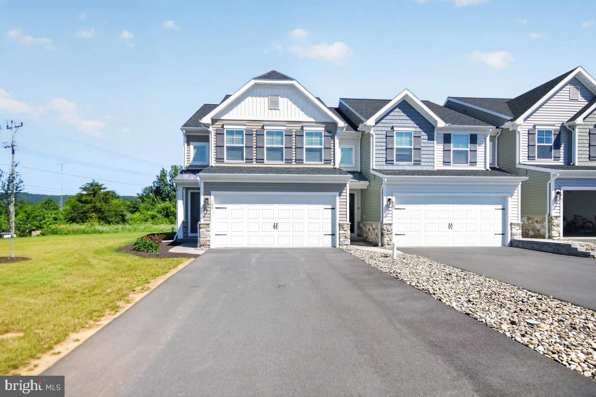 Skip the wait and move right in. This stunning end-unit Lilac townhome at 103 Lantern Lane in Logan Greene was built by Berks Homes in 2025 — and it's loaded. Three bedrooms, 2.5 baths, and an unfinished basement with a 3-piece bath rough-in already in place for when you're ready to expand. More than $40,000 in thoughtfully selected upgrades include an expanded two-story family room, alternate kitchen with recessed and under-cabinet lighting, 60" tile shower with seat, double bowl vanity, composite deck, and garage door opener. Photos are of the actual home and may have been digitally enhanced. The remainder of the Berks Homes 10-year warranty transfers to the new homeowner — peace of mind included.
