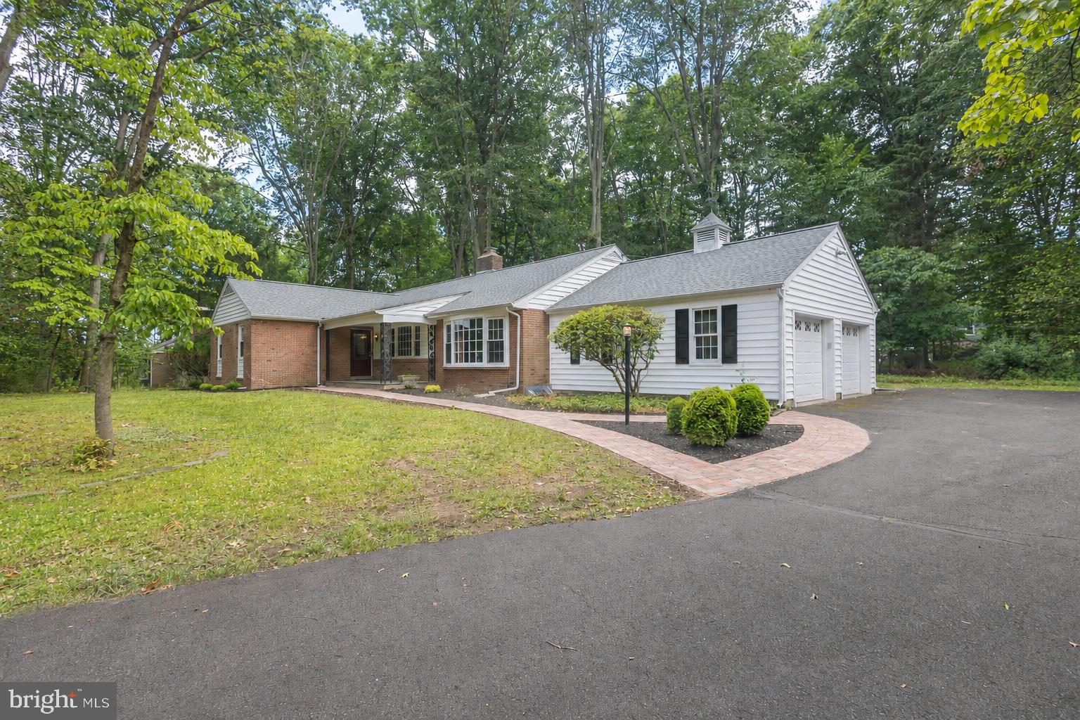 Offered for the first time in more than 30 years, this adorable ranch is a rare gem nestled on a private, shaded one-acre lot in highly desirable Pebble Hill. Thoughtfully maintained and lovingly cared for, the home combines timeless character with numerous important updates, creating an exceptional opportunity for its next owner. A welcoming covered front porch and new brick walkway set the tone, while fresh paint and a thoughtful floor plan make the interior feel warm and inviting. Gorgeous hardwood floors have been revealed and refinished in the great room, with designated areas for hosting dinner parties or enjoying game nights and holiday gatherings together across these generous living areas. The hardwoods extend through all three bedrooms, awaiting your finishing touch beneath the carpeting in two of the three bedrooms. The oversized primary bedroom features three closets and its own en suite bathroom while two additional bedrooms share a spacious hallway bath. A spacious kitchen with center island serves as the heart of the home, with a bright breakfast window framing the picturesque backyard. Replacement windows fill the home with natural light, and the full basement offers abundant storage or the opportunity to create additional finished living space. Major improvements provide peace of mind, including a new roof with gutter guards (2023), new central air (2025), new oil tank (2024), 200-amp electrical service, and UV water treatment system. Outdoors, the spectacular screened-in back porch with cathedral ceiling and fan has been freshly painted and offers the perfect place to relax, entertain, and enjoy the tranquility of the surrounding property. Completing the package is an attached two-car garage, offering both functionality and convenience. Ideally located just south of Doylestown Borough, residents enjoy easy access to charming restaurants, boutiques, museums, and community events. The home is assigned to award-winning Central Bucks School District and is within biking distance of Central Park's playgrounds, pickleball courts, and miles of walking and biking trails. A special property in an unbeatable location, this is a home you'll be proud to call your own.