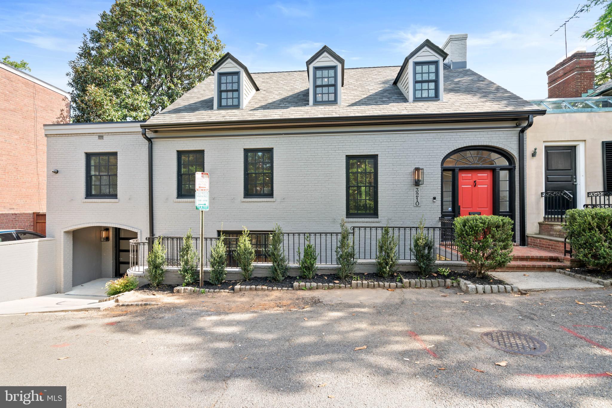 Ideally located in the heart of Georgetown’s East Village, this stunning mid-century residence has been meticulously and completely transformed through a full renovation, showcasing premium fixtures and finishes throughout its highly functional and desirable floor plan. No detail was overlooked in the spectacular renovation of this home, which epitomizes luxury, sophistication, and elegance. As you step into the marble-inlaid foyer, a dramatic glass-railed staircase, illuminated by a contemporary light fixture, gracefully introduces you to the home's various levels, which can also be accessed from the elevator. The main level offers an open and airy living room, complete with wide plank white oak floors, a gas fireplace, built-in shelving and cabinetry, a wall of full glass doors, and access to the large rear terrace. The gourmet chef’s kitchen is well-appointed with a large center island with a striking Calacatta Prado Quartz  countertop, a top-of-the-line Miele appliance package, an attractive La Cornue oven and range, and white oak custom cabinetry. A spacious walk-in butler’s pantry offers access to the glass enclosed wine cellar, and the kitchen flows seamlessly into the dining room, which also opens onto the rear terrace. This level also features a convenient mudroom with cubbies, a full bathroom, and direct entry to the garage.  On the second floor, the luxurious primary suite includes wide plank white oak floors, a gas fireplace, and a large balcony overlooking the private and expansive grounds. The spa-like marble bathroom offers dual vanities, an oversized frameless glass shower with dual showerheads, a large separate soaking tub, and heated floors. The primary suite is complemented by an impressive walk-in closet with an abundance of shelving and storage. This floor also includes an additional bedroom suite with a private bathroom and large closet. Additionally, there is a beautiful family room/library with wide plank white oak floors, built-in bookshelves, a large gas fireplace, and balcony access. The top floor provides two additional bedroom suites, each with large closets and attractive en-suite marble bathrooms with heated floors. The lower level provides ample storage space, a gym area, a laundry room, and elevator access. The exterior of the residence is perfect for entertaining, featuring a large pool with a swim-up bar, multiple terraces for dining, a built-in grilling station, a putting green, and beautifully landscaped gardens and grounds that are expansive and private. This spectacular residence is luxury living in Georgetown at its finest, boasting modern amenities and convenient proximity to neighborhood favorite restaurants, shops, and parks.