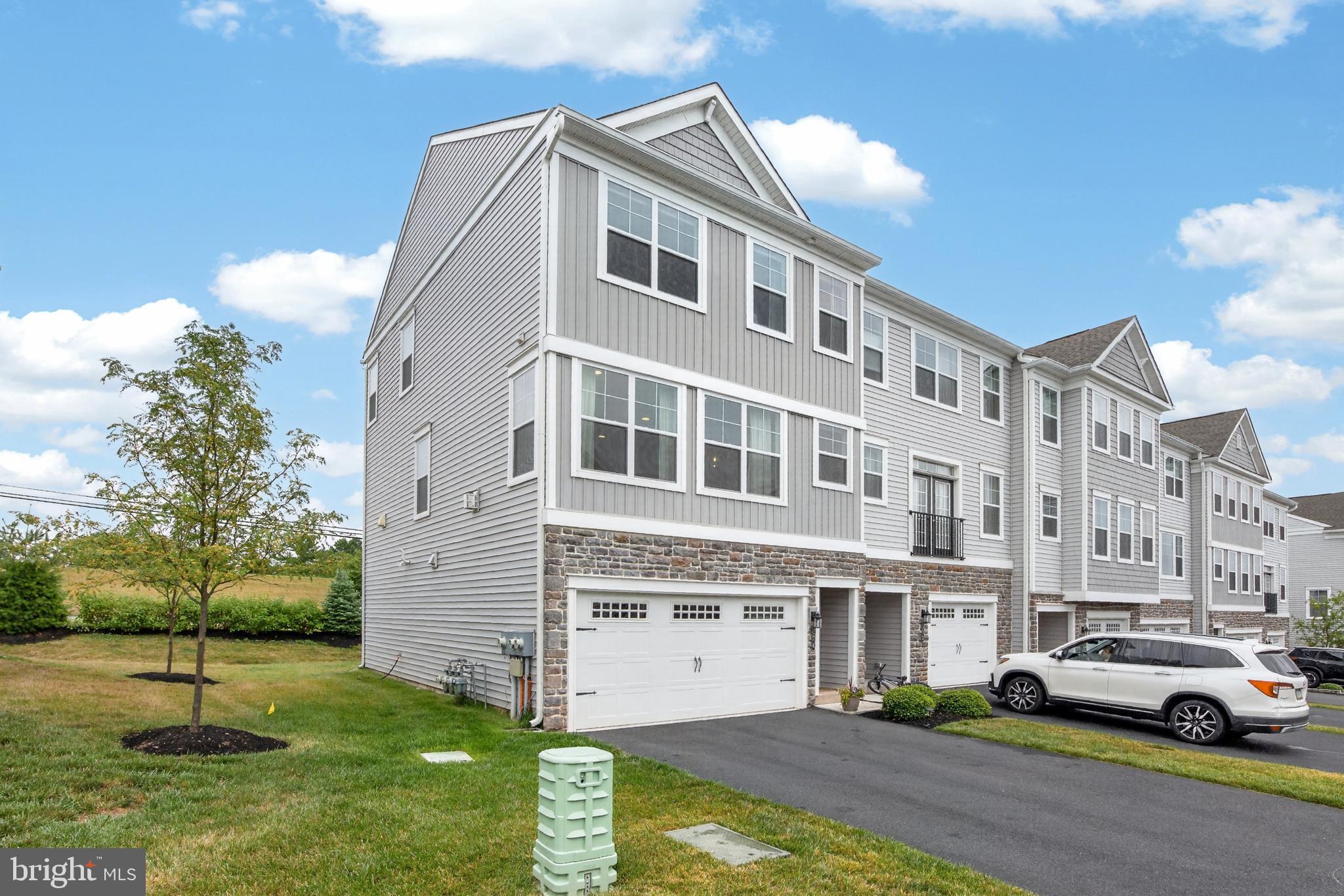 Welcome to 174 Larrabee Way, a luxury townhome in the sought after Spring Ford Area School District. Walk in to find luxury vinyl plank flooring and garage access, as well as a rec area ideal for a home office, playroom or gym, with sliding glass door to the patio. Upstairs you will find an open floor plan with light and bright kitchen with recessed lighting, stainless steel appliances, and expansive kitchen island. The living room features a dry bar, fireplace, and storage closet, with a half bathroom tucked into the hallway. The third level boasts a large primary bedroom with ensuite bath and walk in closet, and two secondary bedrooms that share a hall bathroom. A laundry room finishes out the third level of the home. Located in close proximity to shopping and major commuter routes, this home has it all!