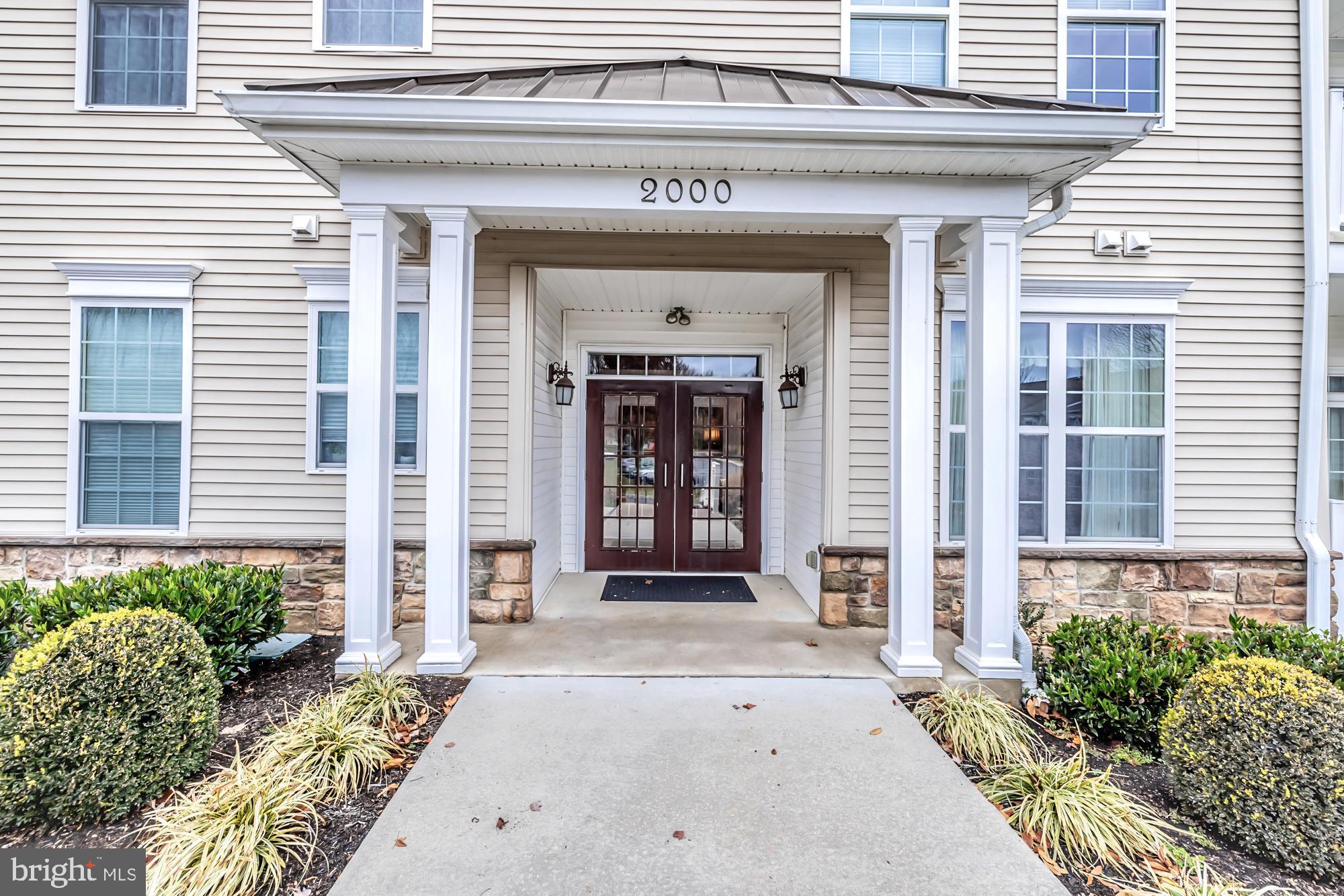 Foxfield End Units don't become available often. This lovely first floor end unit in the 2000 building is really special. The present owner has installed new flooring in the main living spaces. The home is bathed in natural light. There is an entry foyer that opens to the Main living and dining space. You have a full eat in kitchen and a very welcoming bonus sitting/sunroom . There are two bedroom and two bathrooms and a full size laundry room. The home has great closet space, as well as two storage spaces. Oh and did you know that your one car garage is included with the home. Foxfield homeowners enjoy the gorgeous Clubhouse, pool, tennis and bocce courts along with their very own golf course/putting green.  When you enter the secure building, you'll notice a well maintained lobby space. Elevators to the additional floors and also down to the garages. The location can't be beat in terms of access to the airport, great shopping etc. It is an active adult Community.