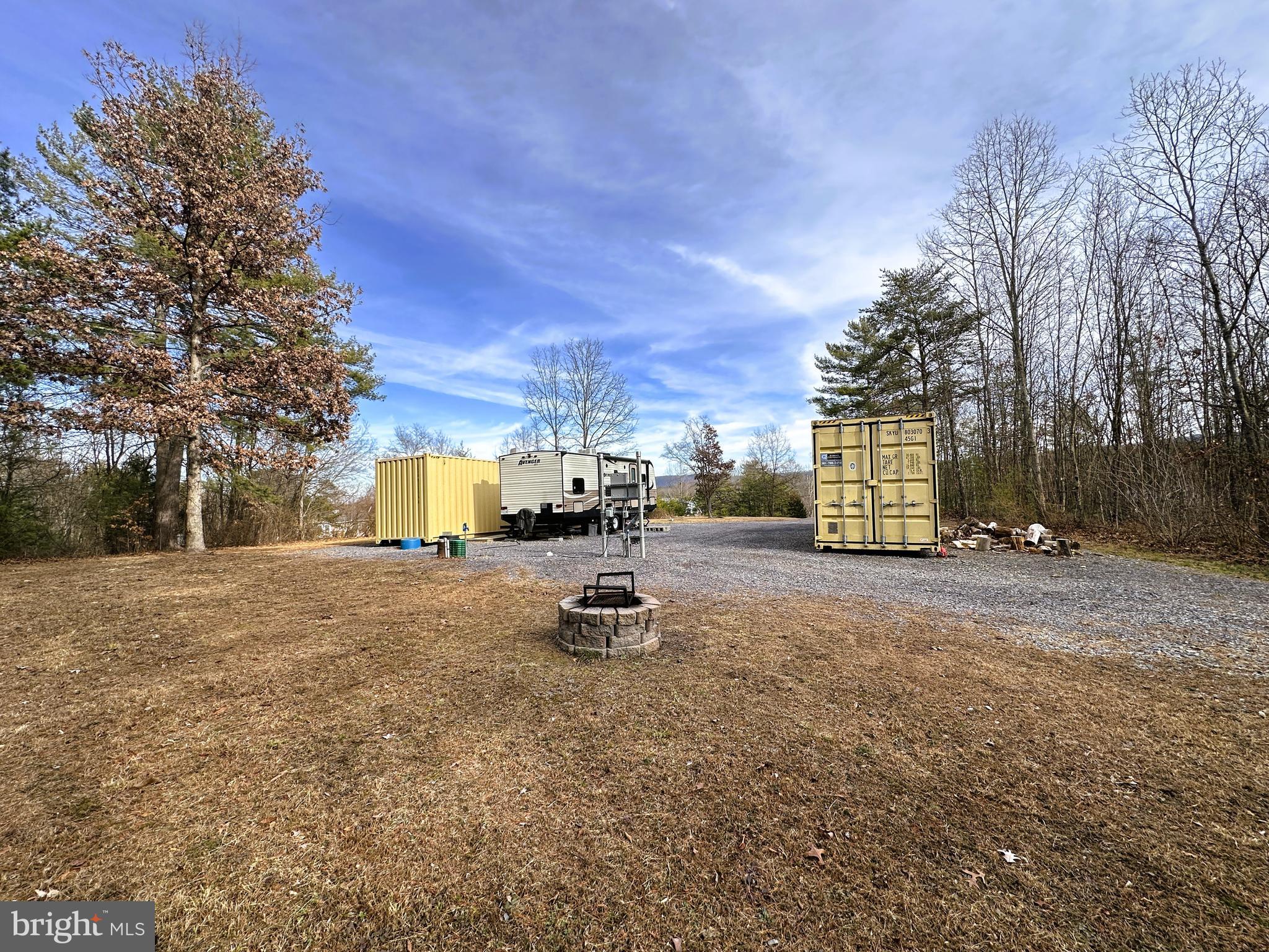 YOU DO THE MATH.....3.7 ACRES OF FLAT WOODLAND THAT'S FULLY FUNCTIONAL AND READY TO ENJOY. ALL UTILITIES IN PLACE; WELL, 3 BEDROOM SEPTIC, ELECTRIC, DRIVEWAY AND 60X60 PAD. 2016 CAMPER & BOTH 8X40 FT SEA CONTAINERS CONVEY, EVERYTHING IS SPOTLESS AND IN EXCELLENT CONDITION. LIVE IN THE CAMPER FULL TIME OR ON THE WEEKENDS......PERFECT SET UP FOR A DOUBLE WIDE, SINGLE WIDE, TINY HOME OR FULL TIME RV HOME BASE....ANYTHING GOES HERE! HERE'S WHAT ALL THIS WOULD COST IF YOU WERE STARTING FROM SCRATCH; SEA CONTAINERS 4K EACH, CAMPER BOOKS AT 12K, ELECTRIC SERVICE 5K, WELL & PUMP SYSTEM 12K, SEPTIC 10K, DRIVEWAY & PAD 5K......THIS ALL TOTALS 52K AND THESE ARE REAL AND ACCURATE FIGURES! LAST TIME I CHECKED 68K - 52K = 16K.....WHAT'S THIS MEAN? IT MEANS YOU'RE GETTING NEARLY 4 BEAUTIFUL & USABLE ACRES FOR 16K....IF THERE WERE NO IMPROVEMENTS ON THIS LAND WHATSOEVER, IT'S WORTH 35K MINIMUM, SO AT 68K, YOU'RE 20K LESS THAN WHAT IT WOULD COST TO REPLICATE IF YOU WERE STARTING FROM SCRATCH! IF YOU'RE NOT GOOD AT MATH, ALL YOU NEED TO KNOW IS THAT THIS IS ONE HECK OF A DEAL! CONVENIENTLY LOCATED ONLY A 1/2 MILE OFF RT 50, JUST 35 MINUTES WEST OF WINCHESTER, VA. THIS IS A REALLY NEAT WELL MAINTAINED PROPERTY THAT CAN BE ENJOYED AS IT IS OR BE UTILIZED AS A READY MADE BUILD SITE FOR ANY TYPE OF HOME. IF YOU DON'T HAVE ANY NEED FOR THE CAMPER OR CONTAINERS, YOU WON'T HAVE ANY TROUBLE SELLING THEM, AS THEY'RE IN EXCELLENT CONDITION. IF YOU'RE LOOKING FOR A DEAL THAT WON'T MAKE YOU SQUEAL, THIS IS IT!