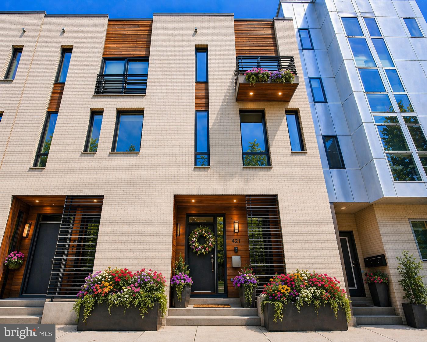 Welcome to 421 Wallace Street, a stunning residence that combines sophisticated urban living with timeless elegance on one of Northern Liberties’ most desirable cobblestone streets.

This exceptional 4-bedroom, 3.5-bath corner townhouse offers a seamless blend of sophistication, comfort, and intentional living, and comes complete with 1 car deeded gated parking located in the rear of the home — a rare and highly sought-after city luxury. Checking every box for the discerning buyer, this home is designed to impress from the moment you arrive.

Step inside to sun-drenched interiors, clean architectural lines, and an open-concept main level designed to both wow and function effortlessly. The generously sized living area flows beautifully into a true chef's kitchen, thoughtfully appointed with built-in stainless-steel appliances, sleek quartz countertops, and an oversized island perfect for entertaining family and friends. Every space feels curated yet inviting — the ideal balance for modern luxury living.

The fully finished basement extends your living experience with limitless possibility — a private lounge, media room, fitness studio, or executive home office — complemented by additional storage to keep life beautifully organized. Calling all workout enthusiasts: this lower level is spacious enough to accommodate both your personal gym and a dedicated work-from-home setup.

Generously sized bedrooms offer exceptional closet space and abundant natural light throughout. The entire third floor is dedicated to a luxurious primary suite — a true private sanctuary featuring a grand walk-in closet, a stunning spa-inspired tiled bath, and a charming private deck perfect for morning coffee or unwinding at the end of the day. Ascend one more flight to discover the fourth-floor entertainer's dream — a spacious bedroom paired with a stylish top-floor wet bar that flows seamlessly out to a breathtaking rooftop patio delivering sweeping skyline views. Whether hosting cocktails under the stars or enjoying quiet evenings in the city sky, this top-floor retreat is truly one of a kind. A private backyard patio adds yet another coveted outdoor space — giving this home three distinct outdoor retreats, a rare combination in the city.

Designed with everyday convenience in mind, this home features dual-entry access from both the rear and the right side of the property, making daily living effortless. Year-round comfort is delivered through a dual-zone HVAC system offering efficient, customized climate control on every level, while second-floor laundry adds another layer of thoughtful functionality right where you need it most. With 18 months remaining on the tax abatement, you'll enjoy significant savings — and for added peace of mind, the seller is generously offering a 1-year home warranty to the new owner.

 Enjoy green space and riverfront views at Liberty Lands Park and Penn Treaty Park, or take a quick walk to Old City, Fishtown, and Center City for endless dining, arts, and entertainment options. For the buyer who values design, comfort, and elevated living, this is the one. Experience it. Own it. Live it.