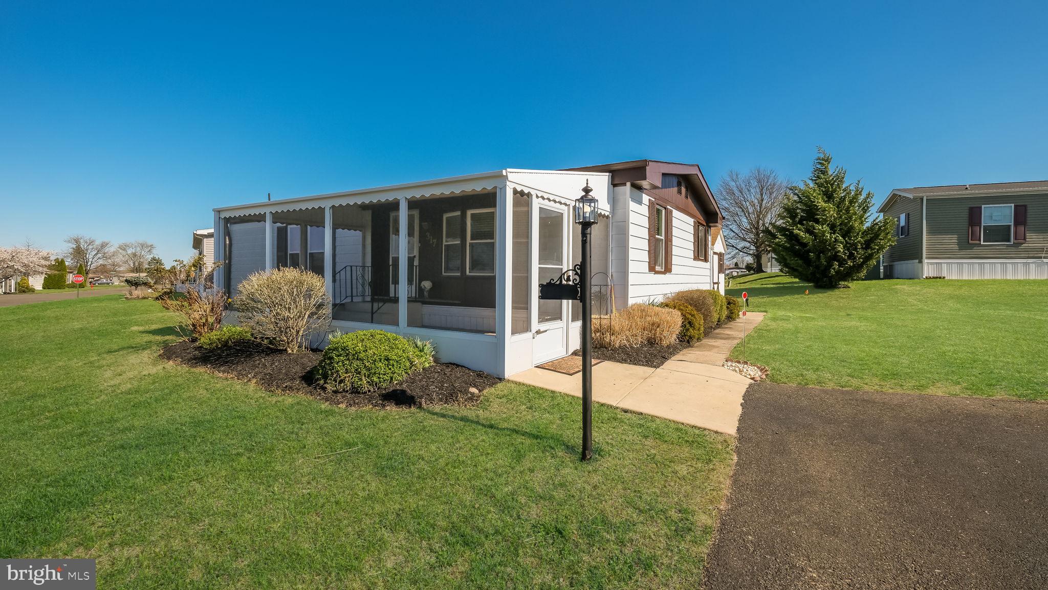 Welcome Home to this beautifully remodeled almost new home like no other!  Warm and inviting the minute you walk through the door.  Enter through a cozy screened  porch into a sun-filled living room featuring an abundance of natural light with a beautiful bow window in front and an additional window offering desirable southern exposure. The kitchen is a showstopper—completely remodeled with gorgeous cabinetry (many with convenient pull-out shelves), a sleek flat-top stove with self-cleaning oven, built-in microwave, dishwasher, and a stainless steel sink perfectly positioned under a window with overhead lighting. New vinyl plank flooring flows seamlessly throughout the home along with six panel doors and new carpeting in bedrooms.  The Master Bedroom takes a queen size bed with room to spare. Remodeled master bath with walk-in shower, high toilet, new vanity, lights, Deep bonus closet in master bathroom with organizer! The Second Bedroom would make a wonderful office and/or reading room. Remodeled Hall Bath has a high toilet, new Light, medicine cabinet and tub surround. You will not be disappointed when you view this Home!! The Roof is less then a year old!  Enjoy a host of amenities that are included in the monthly ground rent such as a new clubhouse and a community pool perfect for relaxation and socializing with neighbors. Trash, sewer, common area snow removal, bus shuttle to local markets also included along with many other wonderful activities. This beautiful home combines style, comfort, and convenience—perfect for enjoying carefree living! Don’t miss your chance to view this beauty—you won’t be disappointed!