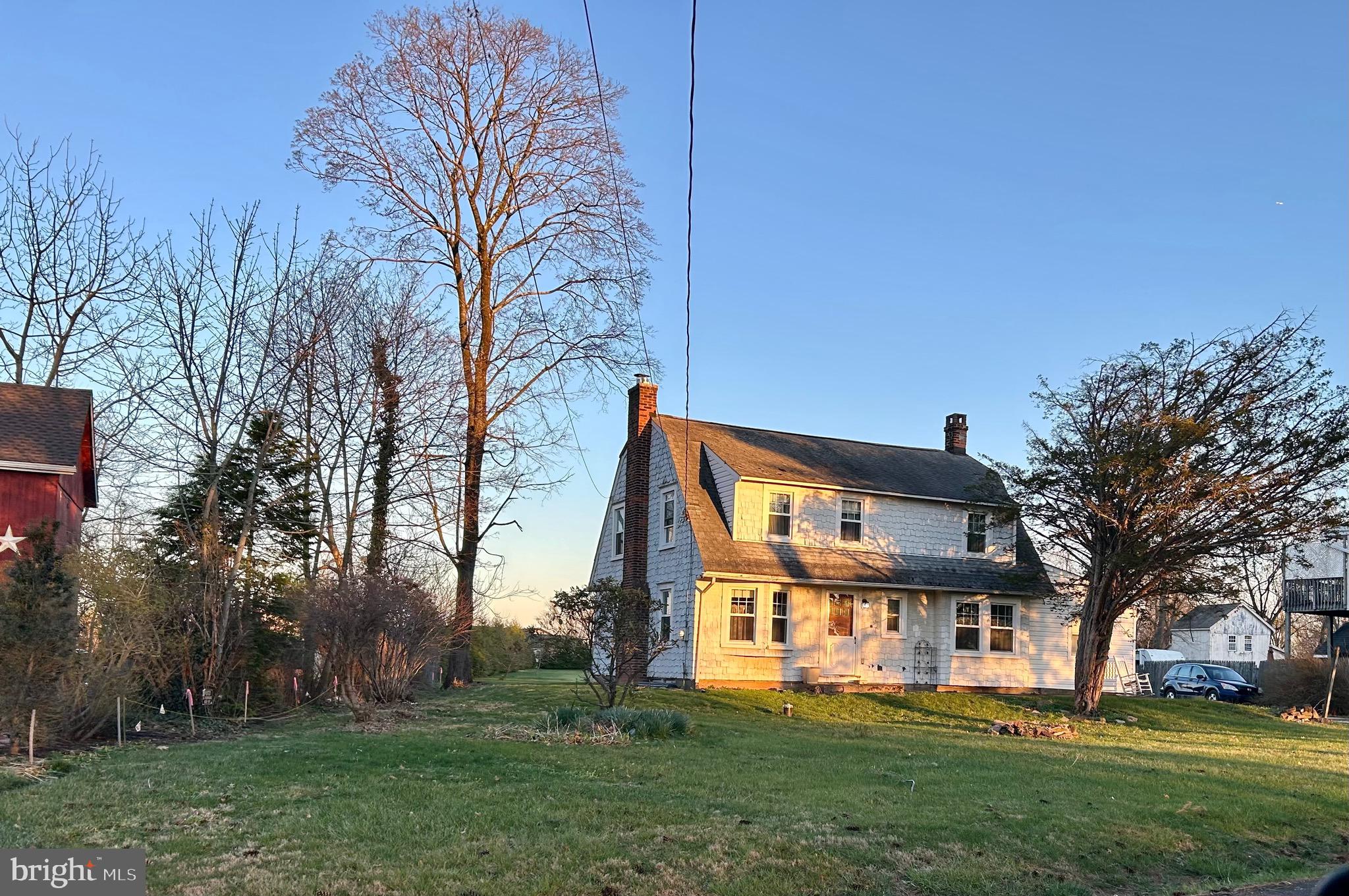 Welcome to the Historic Village of Penns Park of Bucks Co.  This unique Dutch is nestled back beyond the expansive front lawn giving it privacy from the road. The property sits on over .8 acre lot (see exact in Co. records) facing the West in the front and East in the rear with beautiful views as the sunrises and sets, with front and rear patios. This cozy village home has many original features of various built ins, 5 panel doors (most with original hardware), window seats with storage, original cast iron radiators, and more. The living room features a unique v-shaped window with beautiful wooden sill, wood burning insert, closet, and turn step staircase with landing and original wood banister.  The dining room offers plenty of space for a full dining set, built-in window seat & storage drawers, a spacious closet with shelving opposite a built-in glass door display closet.  The kitchen & powder room are newly renovated with shaker style cabinets, quartz countertops, original vanity, bead board and copper finishes respectively.  Adjacent to the kitchen is a cheery breakfast room with 3 windows featuring Roman shades.  Just off of the breakfast room step down into another spacious room with hardwood flooring & plenty of windows. With copious natural light throughout the day, uses can vary from a study, office, to a fitness room and more.

On the second floor there are 3 bedrooms all with generous closet space and wood floors. The master bedroom is very spacious with 2 closets and built in bookshelves. The second bedroom is almost as large as the master with 2 spacious closets. The 3rd room offers another large closet with shelving.  In addition, a bonus room on second floor features a large picture window and a built-in window seat with shelving underneath.  The view from the large picture window is lovely at any time of day. With full sun from morning thru mid-afternoon, it's a great space for an art or craft studio, plants, and more.  The bathroom is newly remodeled, in a style that gives a nod to the original charm of the home with its own built in linen closet. The front of the house faces the West, and the rear faces the East providing spectacular views of sunrise and sunset and excellent cross breezes on lots of spring and fall days.

Just off of the kitchen is the entrance to basement and the mud room of approx. 55 sq.ft. conveniently appointed with the washer/dryer.  At the back or rear entrance there is a spacious cement patio that leads to the lush greenery of the yard.  The 2-car garage has an attached old side shed, 2nd floor storage & its own electric panel.  To the left of the driveway there are 2 cement parking spots next to the back cement patio.  The driveway can accommodate additional parking of 4 to 6+ spaces, convenient when entertaining.

Kitchen renovated 2018-19, Bath renovated 2022, 13 windows new in 2021, Front door replaced 2024, Well pump was replaced around 20-21, back patio recemented in 2020, front patio just replace May 2026, Furnace has been cleaned and maintained yearly, Wood burning stove installed new 2023, Chimney cleaned 2026, Septic maintained every 2 yrs., Electric updated in 2020-21.  

This Charming uniquely situated Village home offers highly desired Bucks Co traditional home living.  The Village is situated just around the corner & down the street from the Grange Fair Grounds (which hosts the Wrightstown Farm Market), Quaint Commercial shopping area, a local Organic CSA and more.  It's within a short ride to iconic Bucks Co. destinations like River Road/ Canal (biking, fishing & more), New Hope, Peddlers Village, Newtown, Doylestown & more!