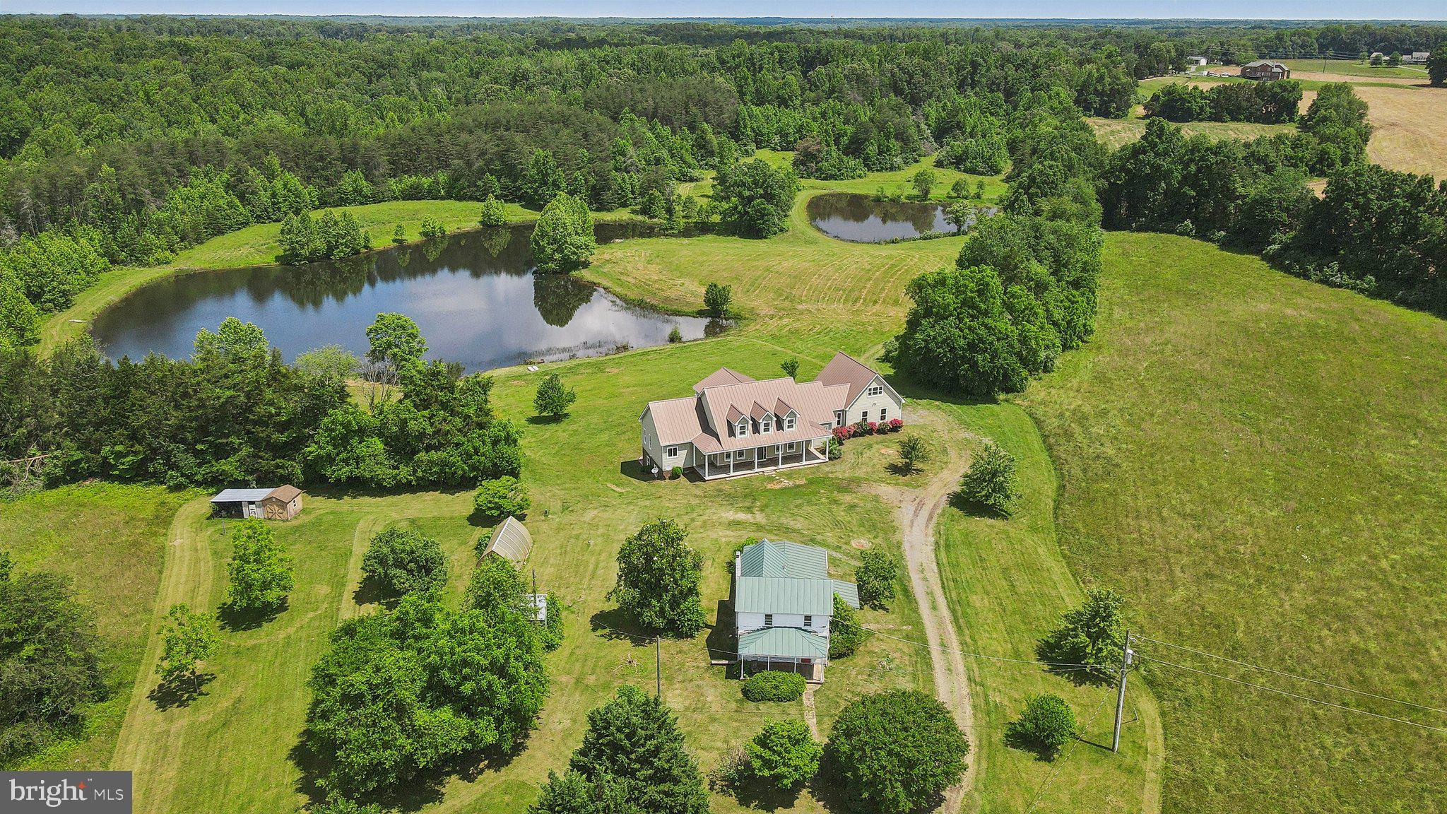 Outdoor thriving at its best, yet close to all. A Rare 57+ acre 3 parcel offering in North Stafford with…

A Luxury Custom Colonial with owner’s suite on the main level, overlooking, not one, but two ponds! “If you can conceive it, you can achieve it!” Your “IT” is minutes to everything your dreams require! Healthcare, food shopping, retail, services, and support, as well as all lines of transportation. Minutes to Quantico, JCITA, FBI, DEA, 95, commuter lots, trains, AND convenient to Westerly back routes on 610 giving access to northern Dulles corridor. Seconds to your private fishing hole and natural landscapes. Whether you or your clientele are coming/heading north, south, east, or west, all are minutes from an “Oasinal” respite:

“Windwhistle Lane”

A Place to Love…
A place to Envision…
A place to Conceive…

A House wherein!.
Your Loves!!..
Are safe to dream!!!…

A soul soothing reprieve…
Amongst life, water, and trees…
Your Home now found…

 !!! Your Being FREED !!!

  Embrace the 5-minute transitional time you will have from pavement to your private parcels, opening to a scenic high point overlooking your “WHY”, a subtle reminder of why you endure the drive Or better yet, just open your eyes, embracing your telecommute “ride”…

  Familial Compound? Homestead Farm? Equestrian Haven? ABNB? Agricultural Tourism Destination? Significant Event Venue? Private Retreat? Private Wildlife/Bird Sanctuary? Private Hunting/Fishing Hole? A Luxury Hunt Club? A Fully Functioning Micro Farm? The possibilities are endless in the now, with possibilities of subdividing as you see fit immediately or when appropriate for your season of life!
  The home conveniently has a one-bedroom studio apartment above the two-car garage with a separate large bath and separate zone heating pump and cooling system. There is also a small food storage and prep area ideal for in-laws, students, rentals, property caretaker’s quarters, or your command post while you customize your 57+ acres!

There are two operational hay fields, and both have been fenced for livestock and horses in the past. The sky is the limit on where you want to raise your chickens, turkeys, peacocks, and guinea hens! 

Additionally, there are several other structures on the property. An original Sears Catalog home on site, an old pump house, a separate workshop with covered storage, a greenhouse, and a large original colonial home designated by the county as a shed. Plenty of room for a range or maybe several “Glamping” locations as well?

This property is equally suited for single-family living and can evolve with your life plan, or a purpose rich phased developmental vision. The options are endless and while you weigh them, the 5-bedroom, 5-full baths are move-in ready, “Too Love, Live, Lead and Thrive”!!!

(Please Review Windwhistle Home Poem/Construction Features and Windwhistle Layout Description in the documents section)