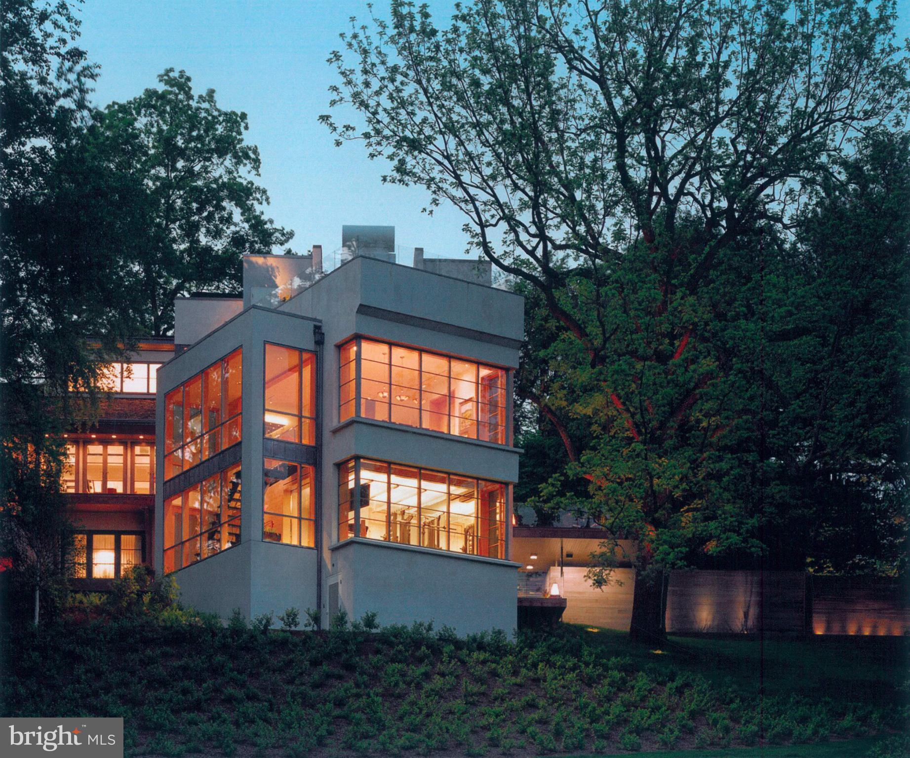 A one-of-a-kind architectural estate awaits on 2.46 secluded acres in the coveted Radnor Township
enclave of Wayne,  308-310 Julip Run spans two parcels (one deed, two separate tax IDs), featuring a 9,238-sq-ft contemporary main residence originally built in1982 and transformed by a multi-million-dollar contemporary redesign in 2007 including a 3,956-sq-ft carriage house/garage. Designed in harmony with nature, the home offers privacy, panoramic views of preserved open space, and proximity to the historic Willows Duck Ponds.
A lantern-lit path leads to the entrance of the one-of-a-kind steel-and-concrete main residence. Immense windows frame every view and flood interiors with natural light. The reverse-level layout provides entry into the second-floor sleek foyer w/ black marble flooring and a dramatic glass-and-chrome staircase. Ahead, a wall of glass in the dining room captures southern vistas. The living room with floor-to-ceiling windows, rosewood flooring, and a scalloped floor-to-ceiling rosewood mantle opens to an Ipe deck overlooking a cascading runnel. A curved-wall library features a 15ft slanted ceiling and built-in bookshelves. A formal powder room features a trompe l’oeil tile floor.
The large chef’s kitchen features bespoke birds-eye maple cabinetry, Saudi Arabian granite
countertops, black marble flooring, and high-end appliances including a Wolf 6-burner gas
cooktop w/ grill, 2 Wolf ovens, Gaggenau steam oven, and Sub-Zero refrigerators/freezer. The
kitchen flows into a sitting area and breakfast nook w/ windows framing views of the 576-sq-ft
infinity pool and 100+-year-old walnut tree. A few steps down, the great room presents
soaring ceilings, maple flooring, custom entertainment center, and panoramic east/south/west
views.
The 1,500 sq ft third-floor primary suite w/ leather flooring includes an office with rosewood screens and desk, bedroom w/ fireplace, sitting area, kitchenette, and 2 full baths. Skylit stairs lead to a rooftop deck w/ a hot tub and unmatched views. A 23K-gold-leaf and onyx rotunda sits between two marble vanities w/ inlaid rosewood cabinets, a 10ft marble shower w/ glass ceiling, and two walk-in closets with center island. A loft provides 500-sq-ft of flex space and storage.
Level one offers three egresses and full windows. There are two bedrooms, two full baths, spacious family/media room w/ cork flooring, gym w/ rubber flooring and sweeping views, 3,000-bottle African walnut wine cellar, and an impressive laundry room w/ storage. 
Additional features include Lutron lighting, radiant-heated floors, 3-car climate-controlled garage, whole-house generator, smart security and a new roof (2025).
Outside, lush landscape design incorporates native plantings and mature trees from the original
estate, a 16’X36’ infinity-edge pool, full outdoor bath for pool use, multiple gardens, fountains, a cascading runnel and bluestone patios.
A shaded path leads to the carriage house/garage on its own 1.06-acre parcel, ideal for guests,
rental, or subdivision. Enter the second-floor loft-style apartment through a curved white oak
wall entrance. The open concept floor plan includes soaring ceilings, a full kitchen, full bath, bar,
and spaces that flow together including an office, dining, sitting area, 1 bedroom area, plus a
private terraced garden. The car enthusiasts garage below includes 2 climate-controlled bays,
Lutron and recessed lighting, a built-in TV/entertainment center, and a wine cooler. Another bay 
offers motorized storage and catering space. There is also an additional bedroom/office w/ murphy bed, full bath and closet. This space has an independent generator and security.
Situated within the top-ranked Radnor School District, close to premier private schools,  shopping, dining,  area country clubs, downtown Wayne, major commuter routes including I‑476, and the Wayne train station (2.1 miles w/ service to Phila. and NYC).