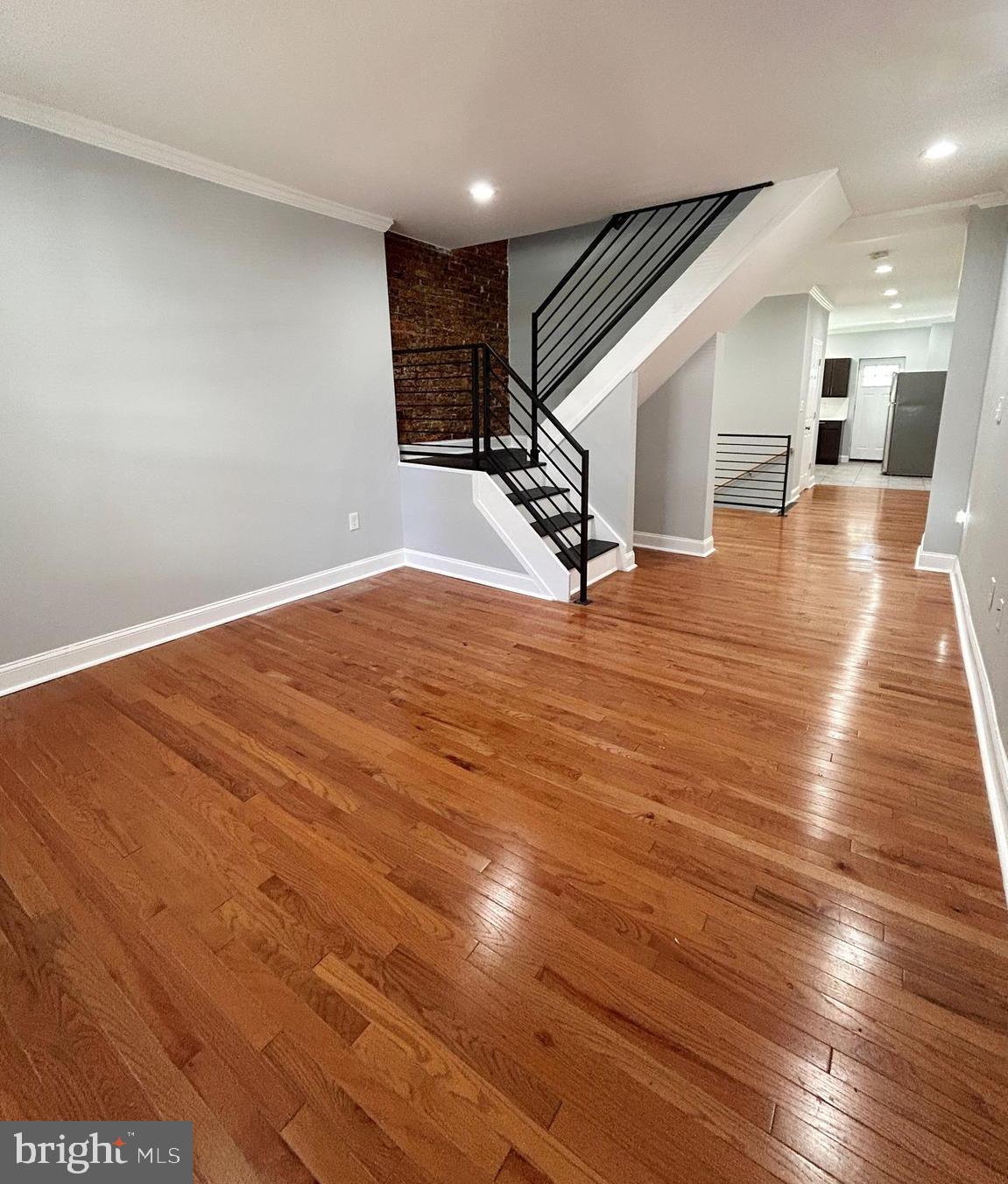 Welcome to this beautifully updated 3-bedroom, 2.5-bath home that perfectly blends modern upgrades with timeless character. Step onto the inviting front porch and into a warm, stylish interior featuring original exposed brick, recessed lighting, baseboard molding, and solid hardwood floors that add charm and personality to the living space. The upgraded kitchen is designed to impress with stainless steel appliances, modern finishes, and plenty of cabinet space.  Head upstairs to find a generously sized primary bedroom with en suite bathroom. Two additional bedrooms and a hallway bathroom provide comfort and flexibility for today’s lifestyle. The finished basement adds valuable extra living space—perfect for a family room, home office, gym, or entertainment area. Out back, enjoy a private backyard ideal for relaxing, gardening, or summer gatherings. This move-in-ready home offers the perfect combination of character, comfort, and thoughtful updates.