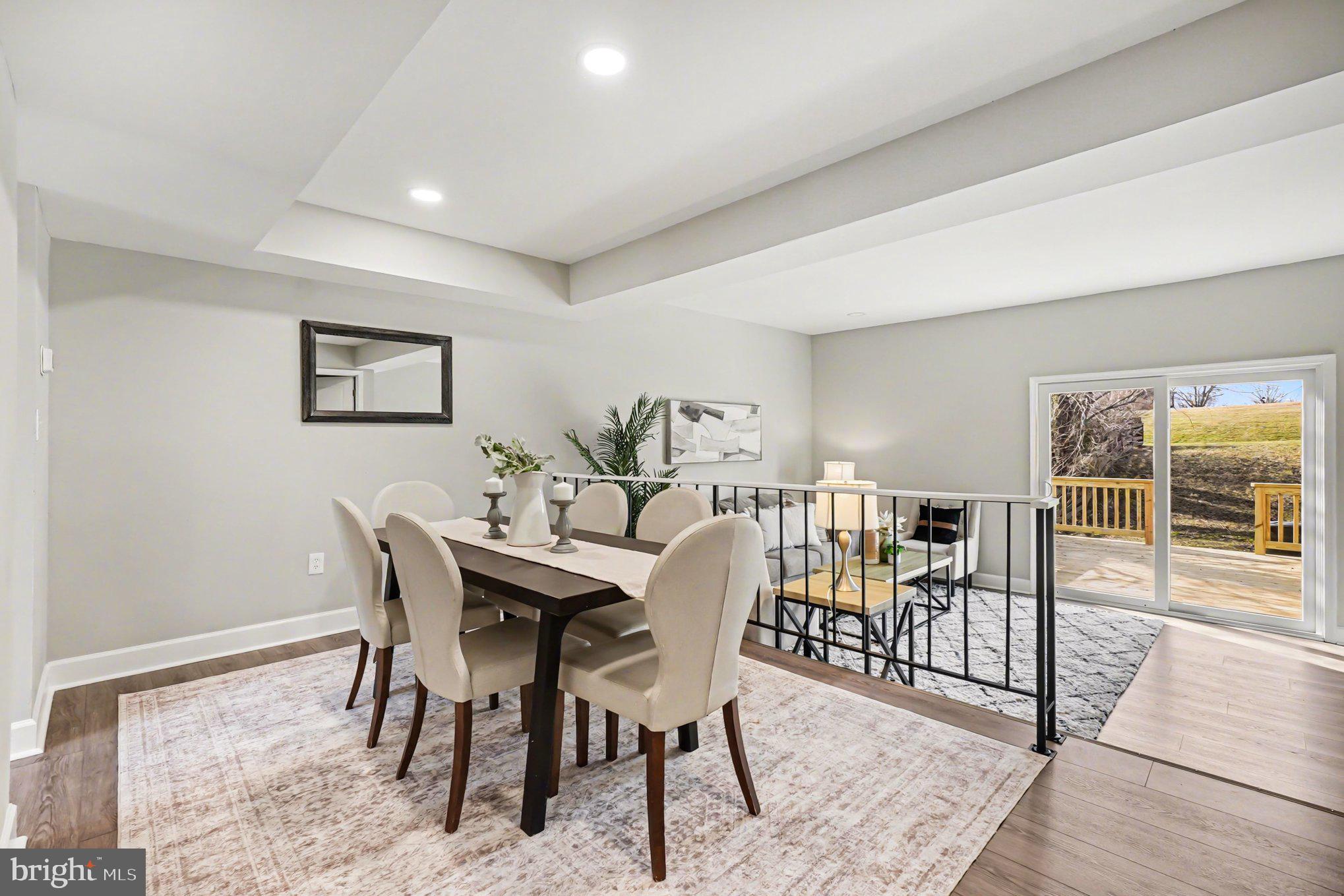 Welcome to 32 Romanoff Court — a fully renovated Seven Courts townhome where nearly everything is brand new. From the moment you walk in, the difference is obvious: new kitchen, new baths, new drywall, new windows, new doors, new roof, new siding, new flooring, and a brand-new oversized deck — all thoughtfully finished in a clean, modern style. The main level offers bright open living and dining space, updated vinyl plank flooring, recessed lighting, and a beautifully redesigned kitchen with white cabinetry, stainless steel appliances, and fresh contemporary finishes. Upstairs, the bedrooms and baths have been completely redone, while the fully finished basement adds valuable flex space for a rec room, office, or guest setup. Out back, the oversized deck overlooks open space, giving you a rare sense of privacy and room to breathe. Set within the Seven Courts community in a convenient Parkville location, this is the kind of renovation buyers hope to find but rarely do — truly move-in ready, beautifully updated, and almost entirely all new.
