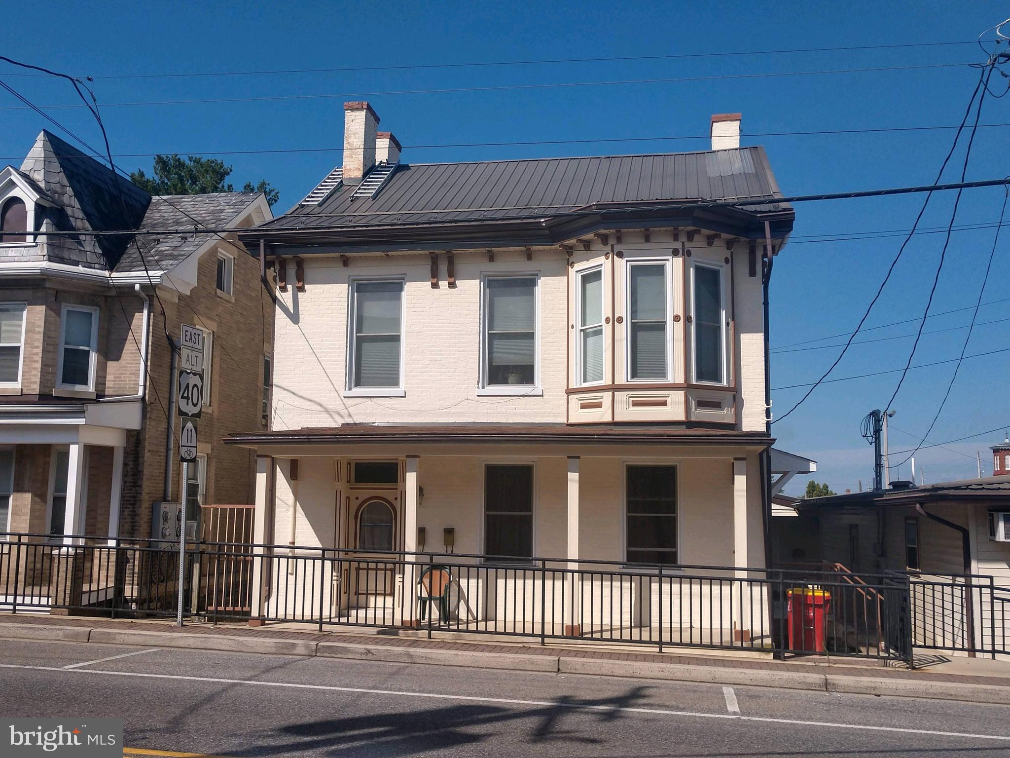 Here’s your chance to own a piece of history in the Town of Boonsboro. The year of construction is unknown, the log cabin was one of the first homes built in Boonsboro in the late 1700s. The home next door was built in the early 1800s and was converted into a multi-use. This unique property offers 4 multi-family apartments and 2-commercial spaces all under one roof and zoned commercial ***NOTE there are 3 parcels 14,16 & 20 Main St. Commercial SF approx. 1925 and fully leased with long-term tenants. The 4 multi-family units are leased, making it income-producing from day one of ownership.  Recent updates & shows well, including roof, plumbing, exterior paint, etc. All electric building & all units are separately metered. The main level apartment is handicap accessible, with a ramp to the door & roll-in shower. The second apartment has 2-bedrooms, 1-bath and a back door leading to a fenced yard & access to the parking lot. Both upper-level apartments have 3-bedrooms with 2-levels and 1-bathroom. Plenty of free parking on Main Street and highly-coveted 15+ private parking spots in the back of the building. Showings are appointment only. Please do not disturb the happy tenants.