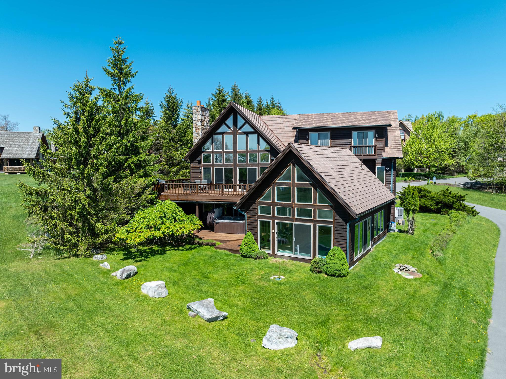 A stunning mountaintop masterpiece located in the ski-in/ski-out community of Boulder Ridge. This slopefront home is sure to impress from the moment you walk in. The mountain and lake views are just endless; you can see for miles. Sitting right beside chairlift #5 on the Main Street slope, this home checks off all the boxes. The abundance of windows affords you the beauty of Deep Creek Lake during any season. The home offers eight bedrooms (three of which are master suites) open floorplan, granite counter tops, hardwood floors and plenty of storage. This home also boasts an indoor swimming pool, hot tub, and a large deck for your enjoyment. You are also just minutes to Lodestone Golf Course, restaurants, shopping, and grocery stores. Established rental "Steden Court". Call today to preview this wonderful home, you will not be disappointed.