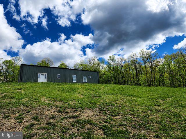 Tucked away on 6.6 private acres, 280 Champwood Ridge Court in Keyser, WV offers a rare blend of peaceful seclusion and everyday comfort perfect for those seeking space, nature, and tranquility.

This charming, modern 3-bedroom, 2-bath home is filled with natural light, enhanced by vaulted ceilings that create an open, airy feel throughout. Cozy up by the fireplace in the living room or unwind in the primary bedroom, which features its own fireplace, an uncommon and inviting touch. The home's open-concept layout creates a bright, spacious feel that is ideal for both everyday living and entertaining. 

Step outside and experience a true nature lover's paradise. The expansive property is dotted with birdhouses and feeders, attracting a variety of wildlife, while deer are frequent visitors making every day feel like a retreat. With plenty of privacy, you'll enjoy the freedom and quiet that's hard to find. You'll find ample parking for multiple vehicles, trailers, or recreational equipment, along with an established raised-bed garden ready for flowers, herbs, or homegrown vegetables.

Conveniently located while still feeling worlds away, the property is approximately:
*  55 miles from Winchester, VA
*  20 minutes to Potomac Valley Hospital
*  20 minutes to ABL
*  30 minutes to UPMC Cumberland
*  45 miles from Deep Creek Lake and Jennings Randolph Lake
*  55 miles to Canaan Valley, WV