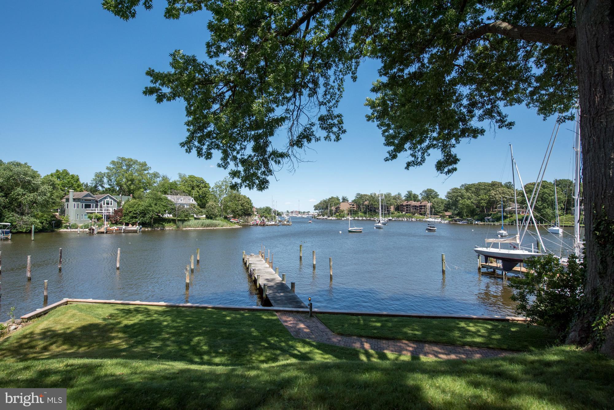 Absolutely STUNNING VIEWS of Spa Creek from this Murray Hill, elevated waterfront with detached 2 car garage. 83 feet of bulkheaded waterfront with pier that will accommodate a large boat with MLW of 7 feet. Stately trees and lush landscaping. Waterside deck from great room and from master BR. Cabinetry, sun-room and open floor plan with water views from most rooms.