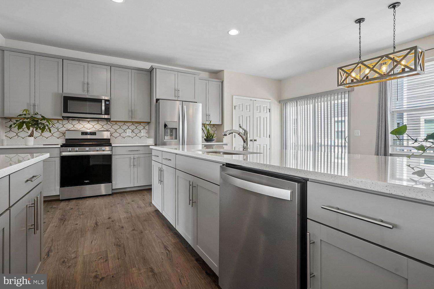 Welcome to a neighborhood that feels like home! Enjoy a lifestyle surrounded by endless opportunities for dining, entertainment, recreation, and commuting convenience. Located in the heart of Lorton, you’ll be minutes from historic Occoquan, scenic parks and trails, golf courses, waterfront dining, wineries, shopping destinations, performing arts venues, and some of the region’s best outdoor adventures. With easy access to I-95, Fairfax County Parkway, VRE/Amtrak, Fort Belvoir, the Pentagon, Washington, D.C., and local transit, this home offers the ideal location for both work and play.

This is a beautifully maintained, tech-enhanced 3-level brick-front townhouse nestled on a quiet private cul-de-sac in the highly desirable Liberty at Laurel Hill community. One owner, built in 2019 and freshly reconditioned in April 2026, this move-in ready home perfectly blends modern luxury, smart-home convenience, and exceptional access to everything Northern Virginia has to offer.

Inside, the open-concept main level features hardwood floors and a spacious layout connecting the living and dining areas to a stunning gourmet kitchen complete with stainless steel appliances, light gray cabinetry, custom tile backsplash, white Concerto Quartz countertops, dual pantries, and a large center island with seating and storage. Step outside onto the rear Trex deck — the perfect space for morning coffee, outdoor dining, or relaxing evenings.

Designed with modern living in mind, the home includes advanced smart-home automation and energy-efficient technology throughout. Seamlessly control lighting, entertainment, climate, locks, and video-enabled doorbells with Amazon Alexa, Google Assistant, or Apple Siri. CAT 6 wiring and a third-floor signal booster provide strong, reliable high-speed Wi-Fi throughout the home, while air quality monitoring, smart leak detection, and preset energy routines create a safe, efficient, and eco-conscious living environment.

Upstairs, the spacious primary suite offers a walk-in closet and spa-inspired en-suite bath with dual vanities, soaking tub, and tiled shower with built-in seating. Two additional bedrooms, a full hall bath, and upper-level laundry provide comfort and flexibility for guests, family, or work-from-home needs.

The lower level features a generous rec room with adjustable spot lighting, a powder room, additional storage, and access to the rear-load 2-car garage.

Combining modern design, smart technology, and unbeatable access to Northern Virginia’s shopping, dining, recreation, and commuter routes, this exceptional home offers the perfect balance of comfort, convenience, and lifestyle.