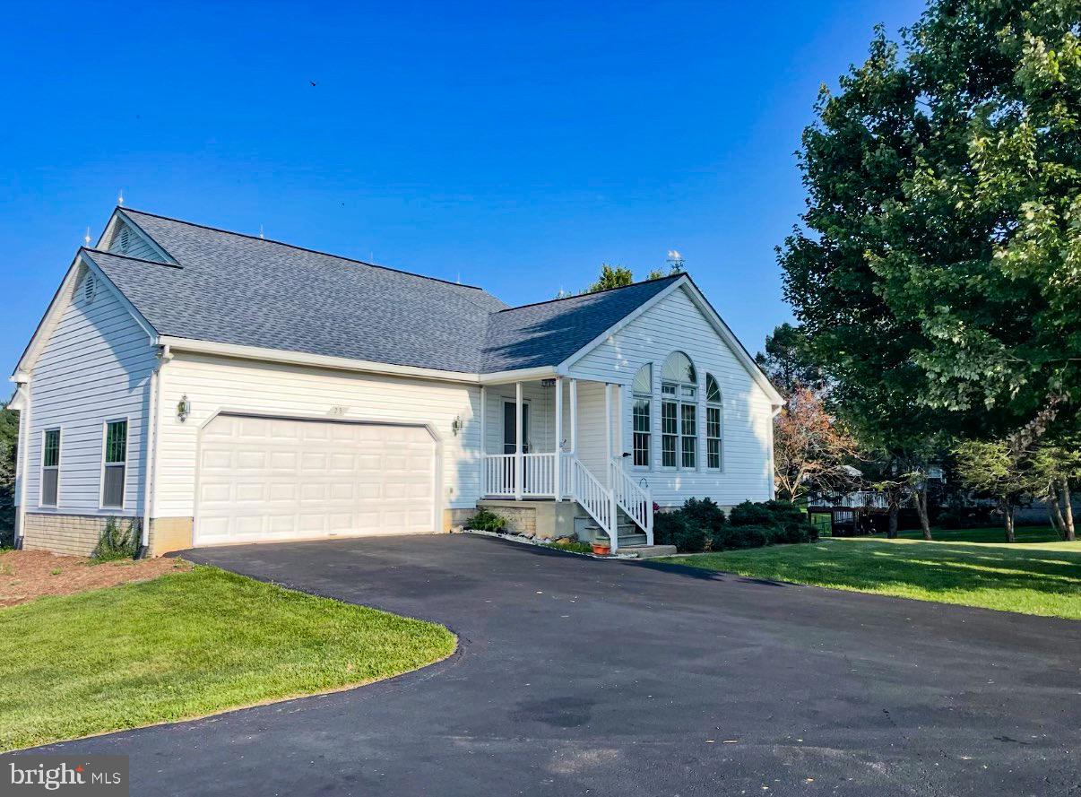 Welcome to 23 Teakwood Court—where generous acreage, single-level ease, and complete peace of mind converge on a quiet Harpers Ferry corner lot. Sitting on a lush 1.55-acre lot in the Norwood neighborhood, this 4-bedroom, 3-bath rambler offers 2,775 square feet of light-filled living tailored for both effortless day-to-day life and weekend entertaining. The main floor greets you with airy cathedral ceilings, fresh interior paint, and brand-new flooring. A bright galley kitchen and dining layout open directly to a screen-enclosed back porch, giving you the perfect front-row seat to peaceful backyard views. Three bedrooms reside on the primary level, including a restful main suite with its own private bath. Downstairs, the fully finished walk-out lower level doubles your options. Complete with full-sized windows, a private side entry, a third full bathroom, and a flexible fourth bedroom, this space easily adapts to a guest retreat, home theater, or private office. Outside, enjoy an attached two-car garage, a wide paved driveway, and a detached shed ready for tools or hobbies. Best of all, major big-ticket updates are already checked off your list: a new roof and skylights installed in 2023, followed by a brand-new HVAC system, water heater, and water softener in 2024. Just minutes from Route 340, historic landmarks, and local commuter routes, this turnkey residence delivers the ideal balance of space, style, and everyday convenience.
