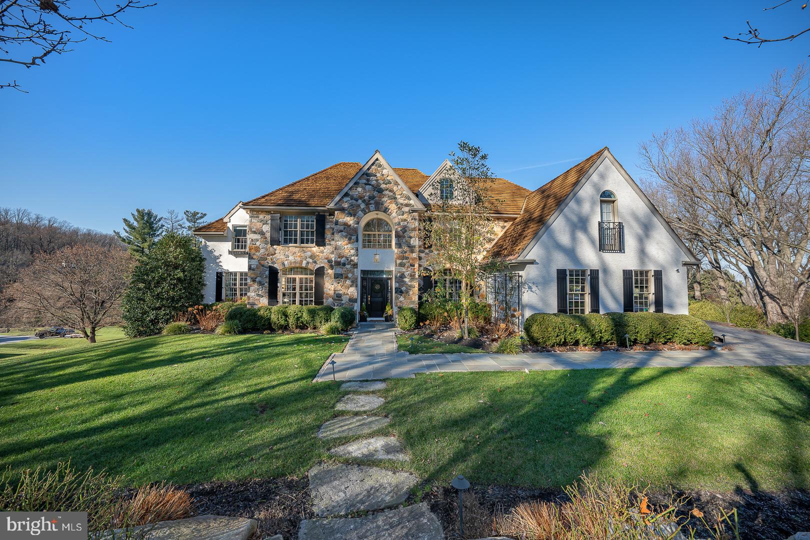 Welcome to this exquisitely renovated home in the sought-after Avonwood neighborhood of Wayne, Tredyffrin Township! The 6 bedroom, 4 full, 2 half bath home offers over 6,500+ square feet of total living space with an expansive finished basement and egress to side yard, and heated path to the fenced in hot tub and pool area.  This house has the most refined features with its premium finishes, including exquisite millwork throughout, double crown molding, beautiful new random length, hardwood floors, new solid paneled wood doors and glass antique styled hardware, new and high-end light fixtures inside and out, tall ceilings, top of the line gourmet kitchen with new appliances and custom cabinetry that opens to the cathedral ceiling family room and breakfast room, all new custom bathrooms, and much more. Enter a gracious, two-story front hall with a transverse staircase leading to the second floor. To the right of the front door is a cozy den/office with glassed French doors and custom office built-ins.  To the left is the family Billiard room, formal dining area, and living room, surrounded by large, sun-filled windows and a French door to the outside living area, providing incredible views from every angle. Straight ahead is a formal powder room, access door to the basement, and a stunning, completely renovated gourmet kitchen featuring a bar area, coffee nook, 6 burner gas stove with griddle, double oven, expansive marble and butcher block island with seating for 5+, farm sink, designer hood, and custom cabinets. The kitchen is open to the glass surround, eat-in dining area, and cathedral-ceiling family room with a gas-burning fireplace and custom millwork from floor to ceiling.  Enjoy the wall of windows and multiple glass doors with access to the private outdoor dining and copper standing seamed roof pavilion that covers the living area with wood burning, stone surround fireplace, overlooking the lap pool and breathtaking sunset views for miles.  Back stairs to the second floor, a built-in cubby mudroom with radiant heat, and a desk area complete the first floor.  The spacious main ensuite includes a large walk-in closet, a Juliet balcony, a spa-like bathroom with a whirlpool tub, an oversized shower with double shower heads, and two marble vanities. Two other bedrooms with California closets share a hall, tub/shower combo bathroom with double vanity.  At the end of the hall, and the top of the back steps, is laundry, a small balcony overlooking the first-floor family room, stairs to 3rd floor, and an en suite bedroom with a sitting area and a Juliete Balcony. The 3rd floor is currently home to a bedroom but can also be a wonderful space for kids to hang out, a “mancave,” or an office.  There is ample storage and built-in shelving as well.  The basement is equipped with tall ceilings, an at-home gym room, game room, TV area with gas fireplace, sauna, powder room, kitchenette, a second laundry room, an additional en suite bedroom, and mud room access to an outside yard, hot tub, and pool area.  The attached, oversized, 3-car garage is heated, holds multiple built-in cabinets for organized storage, and has a utility sink, refrigerator, and temperature-adjustable wine fridge. The outside is well-landscaped with lighting, an irrigation system, a new circular driveway, and flagstone walkways. The two-level, fenced-in, outside flagstone terrace by the fireplace, pool, or hot tub is perfect for entertaining and relaxing.  Enjoy the home's manicured yard and 1 acre + of green space that serves as the neighborhood hang-out for sledding, games, and much more. The neighborhood is bustling with activities and just steps from New Eagle Elementary, one of the best elementary schools in the area. A short ride to trails at Valley Forge Park, shopping and fine dining at the King of Prussia Mall, Wayne, and Berwyn, and close to all state roads, public transportation, and the best public and private schools in the country.  A must see!