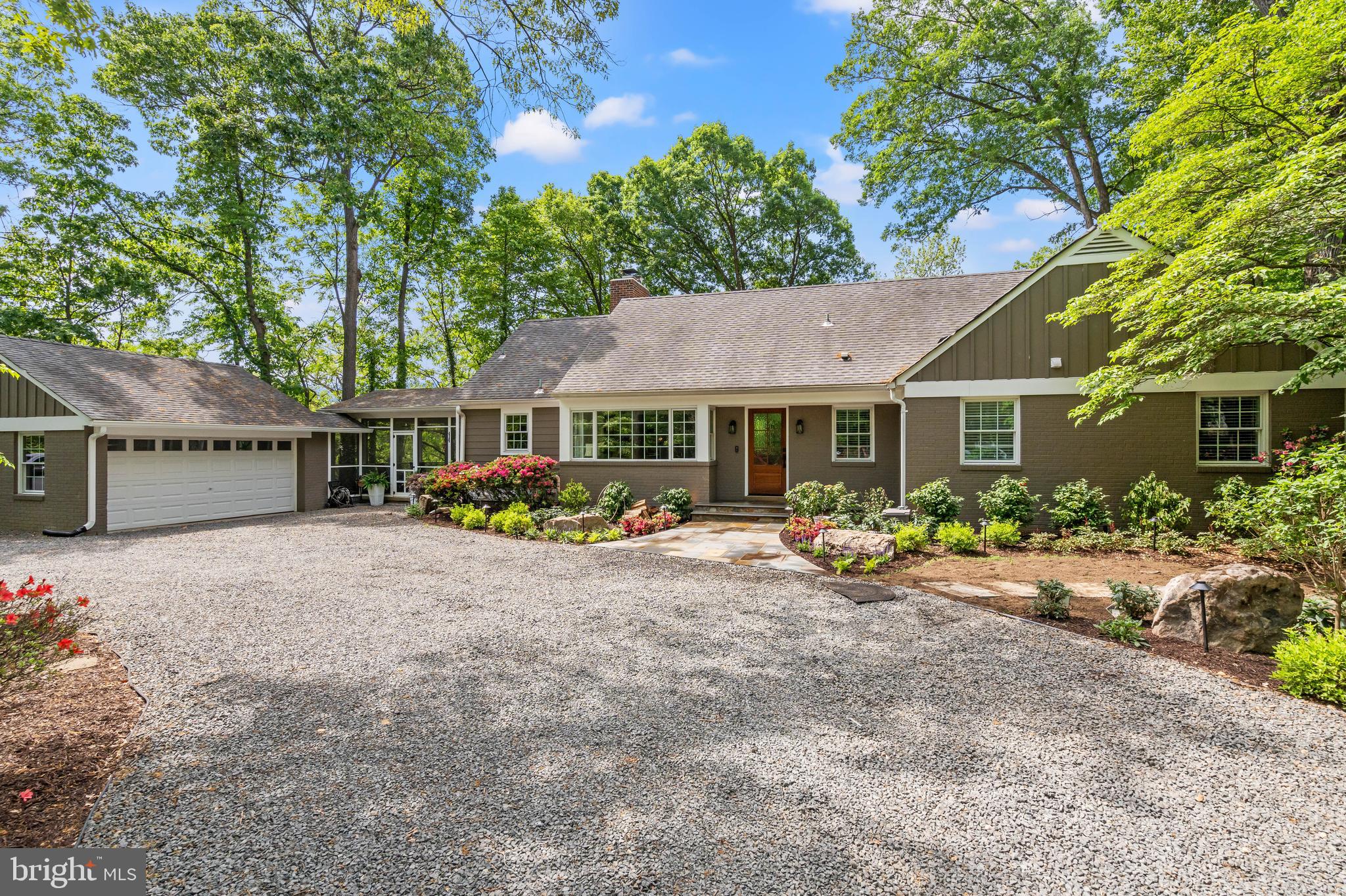 Nestled on a secluded, wooded 1.1-acre parcel in the heart of Alexandria City, this gorgeous family residence offers a singular combination of tranquil countryside vibes with urban convenience. Prepare to be delighted as you enter and explore a dwelling meticulously renovated for both relaxed family life and effortless social gatherings. Nothing was left untouched in the transformation of this spectacular home. Boasting five bedrooms and four and a half baths, main-level primary, storage galore, a walk-out lower level, and all the bells and whistles. Arrive via the wide, circular driveway or the two-car garage and step into the foyer. You will be greeted by a formal sitting room overlooking a generous dining area with a gas fireplace. In the new two-story addition toward the rear, discover the heart of this home - a chef's kitchen with soaring ceilings and ample natural light, flowing into the great room and a sheltered rear deck ideal for morning coffee amidst the treetops. Envision crafting culinary masterpieces on your 48-inch dual-fuel Thermador range, surrounded by your oversized island, marble countertops, coffee bar, and much more. Whether you're hosting intimate gatherings or grand celebrations, this culinary space is crafted to impress. You will love the side entrance and mudroom adjacent to the sizable butler’s pantry and laundry room, making chores simple and convenient and main-level living a breeze. Just off the mudroom is an attractive screened-porch. With its haint blue ceiling and wired for sound just like the great room, this spot is perfect for sipping lemonade and hosting summer brunches!  Rounding out this floor is a luxurious primary retreat. Rarely found in Alexandria, this main-level sanctuary is what dreams are made of! From the custom office nook to the closets to the porch to the bath - every element was deliberately conceived to make this space both functional and a true haven for unwinding. The en-suite bath showcases two marble-topped vanities, elegant sconces, Carrara tile, a separate water closet, and a "wet room" with a stand-alone soaking tub and multi-head shower. Indulge in heated floors throughout and a heated towel rack to melt away the day’s stresses. Upstairs, two airy bedrooms share a completely renovated bathroom with a double vanity. The bedrooms each offer extra storage or play rooms - wonderful for a hideaway or snuggling up on the window seats with a good book. Step downstairs to find an incredible walk-out lower level, extending the possibilities for comfortable living and entertaining. This versatile space features a spacious bedroom, a full bathroom, and a dedicated storage or fitness room to meet your needs. Picture evenings spent in the inviting recreation room, gathered around the wood-burning fireplace, perhaps with a drink prepared at the wet bar. A built-in desk area offers an ideal spot for work or study. The nearby separate kitchen makes it the perfect venue for movie night or to watch the big game! Adding even more value and versatility is a new addition with its own entrance. This thoughtfully designed area functions beautifully as an in-law/au pair suite, offering a private living area, a full bathroom, and bedroom. The walk-out access seamlessly connects to the serene outdoor area, making it idyllic for indoor-outdoor living and providing a sense of escape. The back features a tree-house playground with slides and swings, a sweeping stone terrace, and the potential for an outdoor kitchen or pool. Conveniently situated, this exceptional property offers the ultimate refuge - without sacrificing easy access to all necessities. You are close to I-395, Del Ray, Old Town and Reagan National Airport. With all new systems, windows, plumbing, electric and so much more - see documents for the complete list - you can settle in with peace of mind. Welcome home!