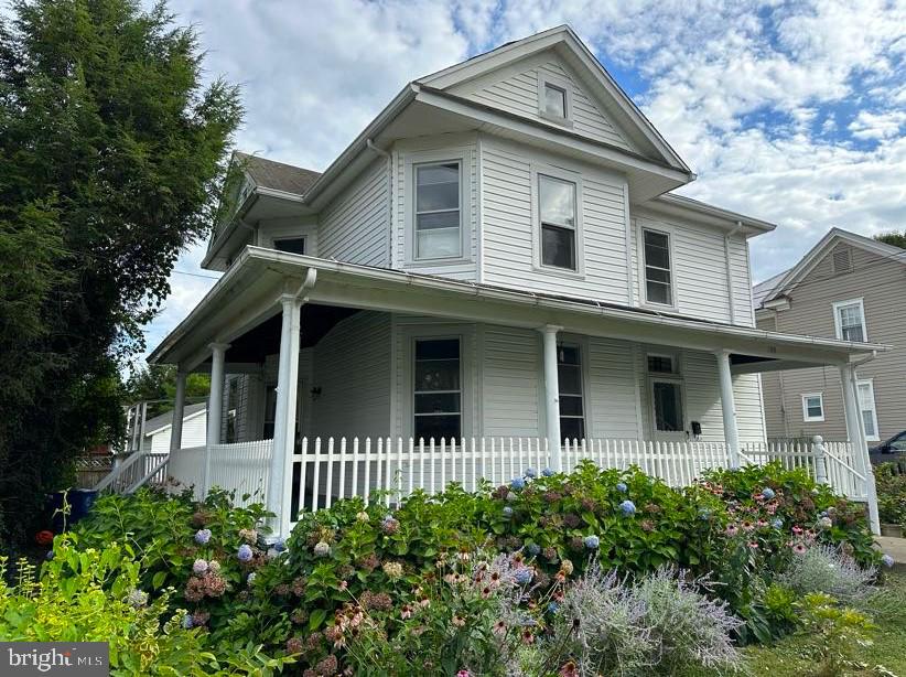Looking for a farm house-in town?  This home is located on a quiet street, just blocks from downtown.  The location is ideal for a private home or take advantage of the R-3 zoning and bring your business dreams to life! The rear section of the home has been converted to a private apartment, with interior and exterior access, a full kitchen, living room and bedroom and is perfect for multi-generational living, a primary suite or workspace. The enormous barn/garage offers space for chickens and/or a workshop.  You'll have room for at least 4 cars! The main house radiates an old world charm, enhanced by the oak flooring and staircase. The ground level of the main home features formal living and dining room spaces with tray ceilings and tall windows. The kitchen features cork flooring, brand new appliances and table space. You will find four of the five bedrooms on the second floor of the home and with pine floors and cedar closets. The property is truly one of a kind with its antique beauty, modern conveniences and upgrades. New water heaters in 2022, on-demand tankless water heater upstairs. Three zoned central air. Gas fireplace. Custom Tile. New appliances. Updated and upgraded fuse box and electric service.
