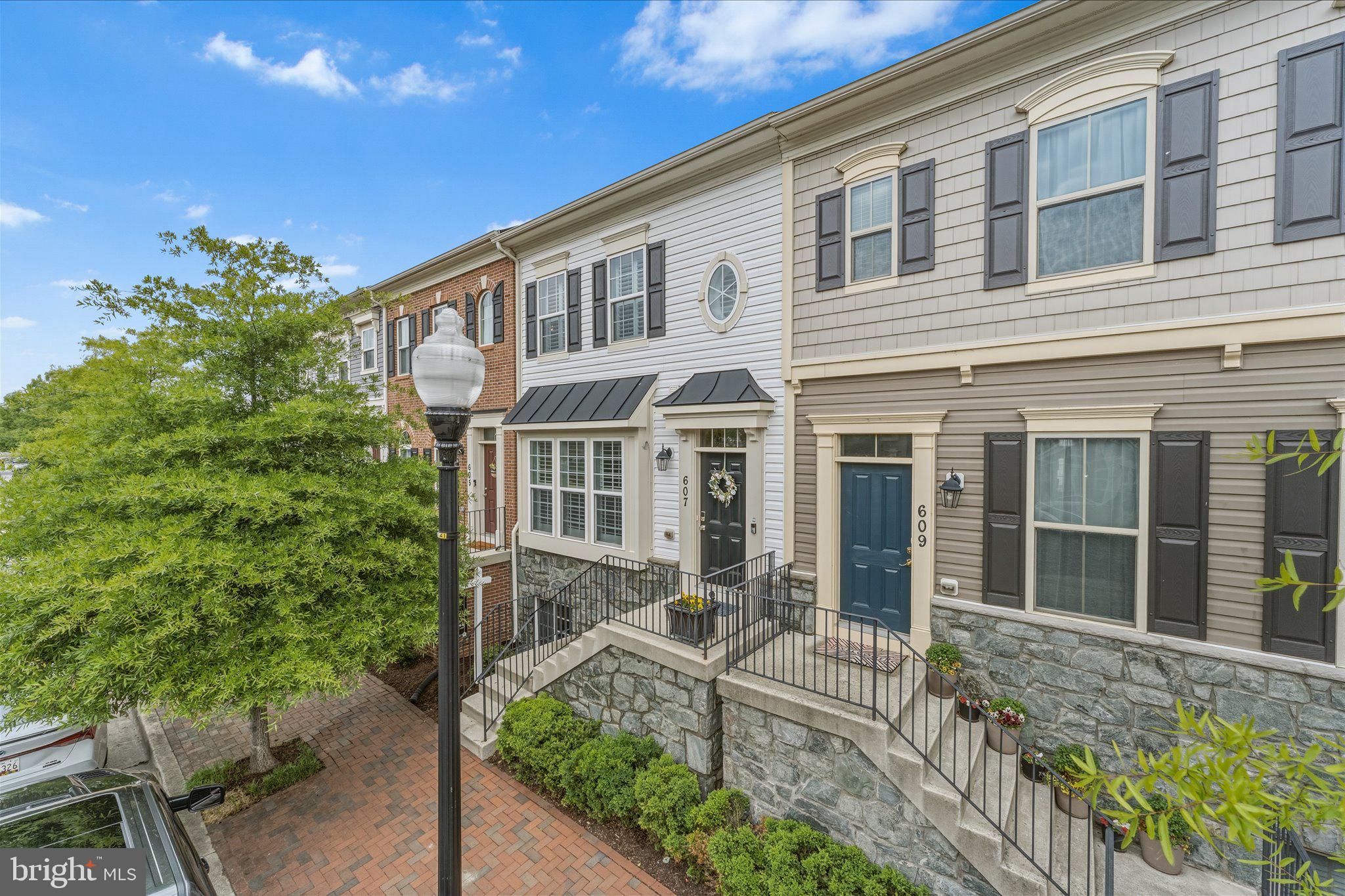 Welcome to Village Greens — Where Annapolis Living Reaches Its Full Potential. Tucked along a tree-lined streetscape that delivers that quintessential Annapolis vibe, this stunning 3 BR, 2.5 BA luxury townhome checks every box. Step inside to an open concept main level where rich hardwood floors flow beneath soaring ceilings, plantation shutters grace every window, and modern updated lighting plus freshly painted spaces adds a polished, contemporary feel throughout. Upstairs, vaulted ceilings continue to impress. The primary suite is a true retreat — custom walk-in closet, soaring ceilings, walk-in shower, soaking tub, and a double bowl owner's vanity. Gorgeous LVP flooring runs throughout the upper level, combining beauty with durability. A true basement with windows sets this home apart — bright and full of possibilities, with a plumbing rough-in already in place for a future bath. Outside, gated rear access leads to private resident parking pads and garages, keeping the neighborhood's gorgeous streetscape beautifully uninterrupted. Minutes to Route 50 puts Baltimore, D.C., and the Eastern Shore within easy reach — yet you're squarely in the heart of Annapolis, minutes from world-class waterfront dining, the iconic City Dock, Quiet Waters Park, and everything that makes this city so beloved. Fresh crabs, sailing, brick streets, and the Naval Academy — this is the Annapolis lifestyle, beautifully lived. Schedule your tour today!