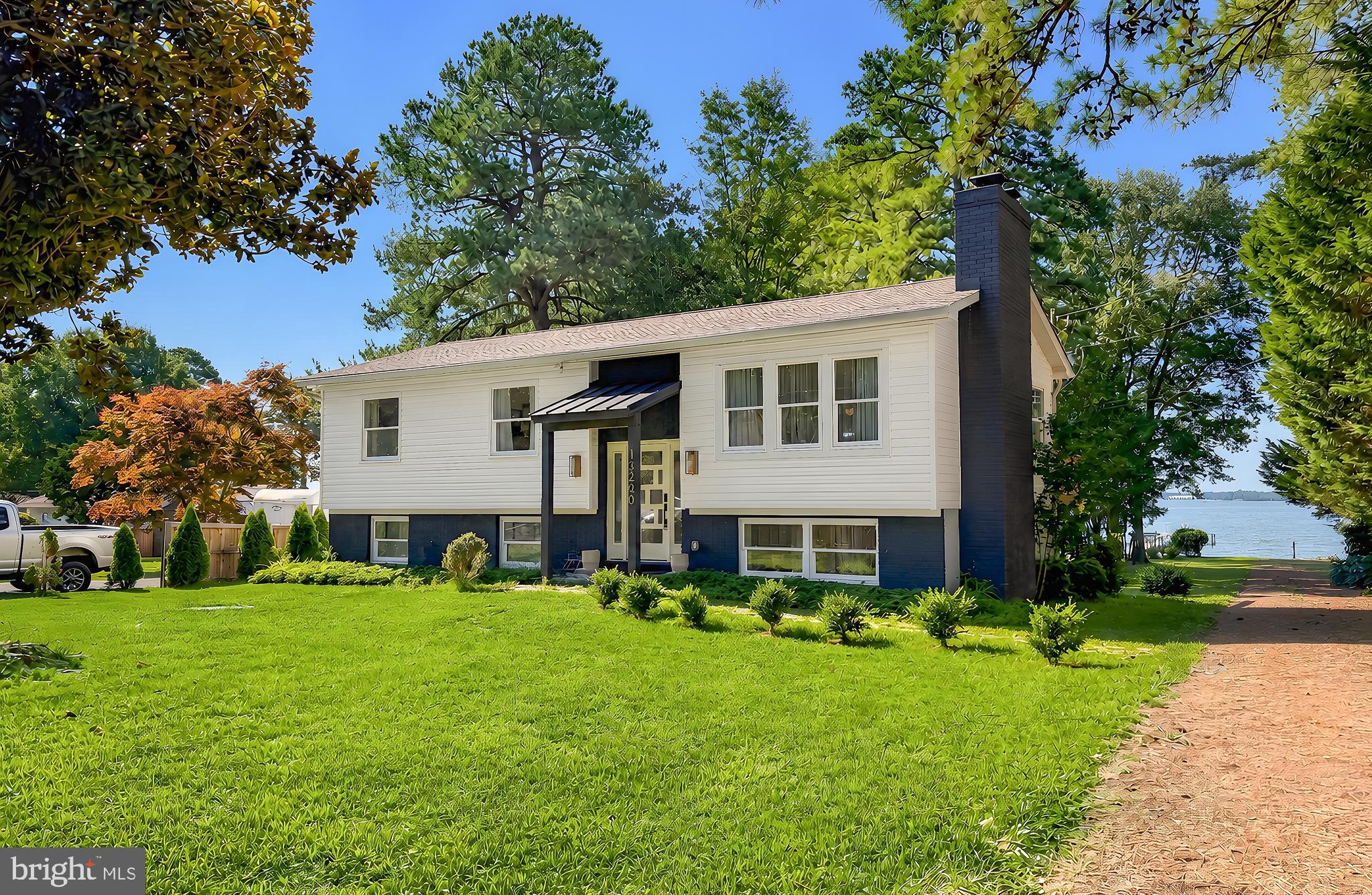 *Professional pictures coming soon.  Welcome to 13240 Trenton Avenue, where stunning mid-century modern design meets today's modern lifestyle. Completely renovated in 2022, this move-in-ready home has been thoughtfully redesigned from top to bottom with high-end finishes, quality craftsmanship, and attention to every detail.

Offering 4 bedrooms, 2.5 bathrooms, and approximately 2,100 square feet of finished living space, this home blends style and functionality. The bright, open main level showcases gorgeous finishes, an updated kitchen with modern appliances, and beautiful design elements throughout. The spacious primary suite features a private en-suite bathroom and generous closet space, creating the perfect retreat.

The fully finished lower level expands your living options with two additional bedrooms, a large flexible space ideal for a living space, home office, gym, or playroom, plus a stylish bar area that's perfect for entertaining family and friends.

The backyard offers breathtaking views of the Patuxent River, creating a peaceful setting that's hard to find. Whether you're enjoying your morning coffee, watching the sunset, or gathering with friends, the scenery is simply unforgettable.

Perfect as a full-time residence or a weekend escape, this home offers the ideal opportunity to leave the hustle and bustle behind while remaining within an easy drive of Washington, D.C., Baltimore, and Annapolis. Every detail has already been thoughtfully completed—from the renovation and designer finishes to the appliances—making this truly a move-in-ready property where you can simply unpack and enjoy.

If you've been searching for a one-of-a-kind home that combines timeless mid-century modern style, modern conveniences, and spectacular water views, 13240 Trenton Avenue is ready to welcome you home.