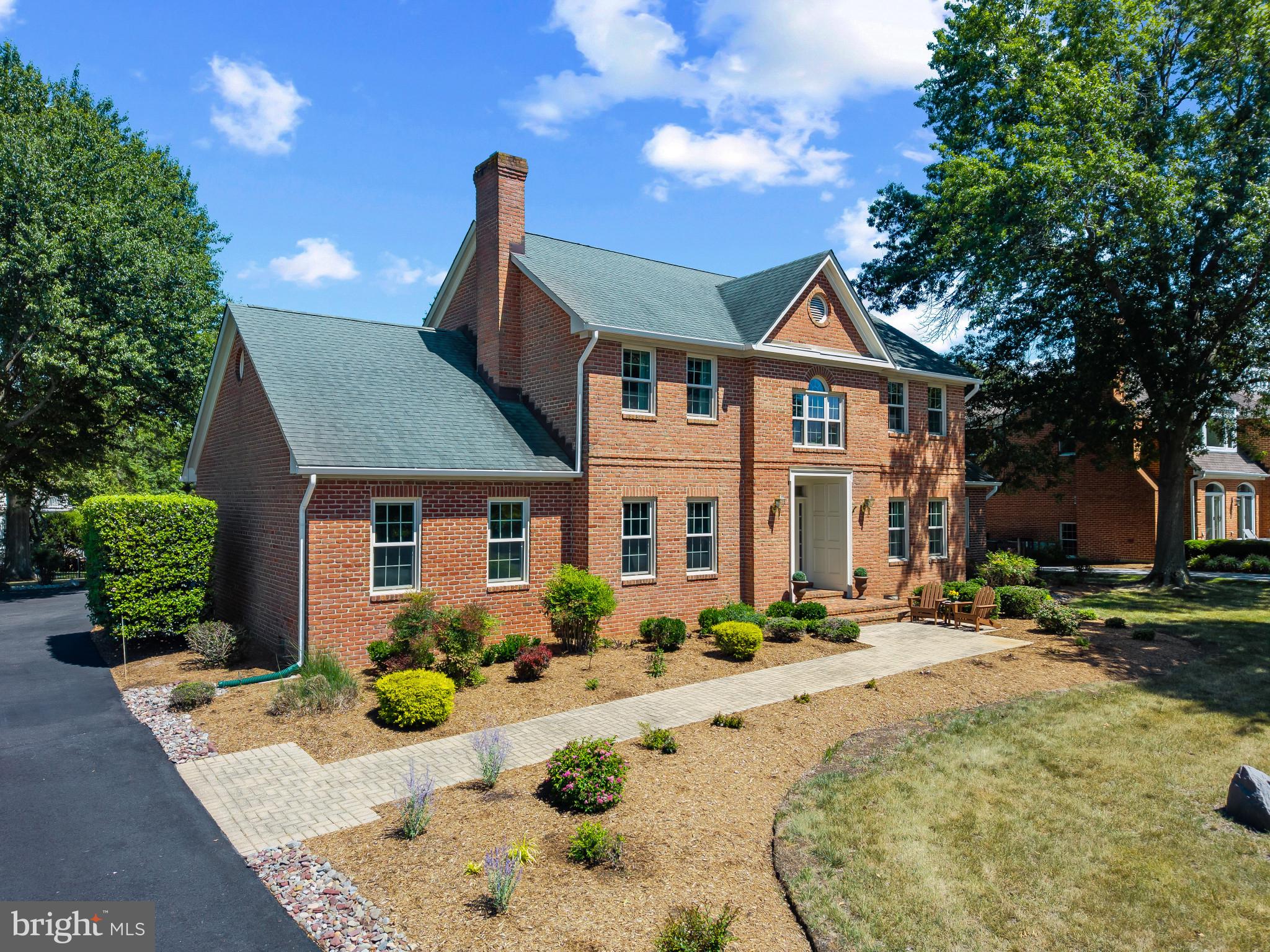 Experience the best of Annapolis living in the sought-after, amenities-rich community of Fishing Creek Farm. Perfectly positioned to capture beautiful water views and surrounded by lush lawns and mature landscaping, this handsome brick-front Colonial offers a rare combination of timeless architecture, flexible living spaces, and an exceptional neighborhood lifestyle.

A gracious foyer welcomes you into formal living and dining rooms designed for entertaining, with the current living room serving as a billiards room. At the heart of the home, the bright white kitchen features quartz countertops, abundant cabinetry, and a sunny breakfast nook that flows seamlessly into the impressive family room with soaring vaulted ceilings, a fireplace, and easy access to the patio and expansive backyard. Whether hosting summer gatherings or enjoying a quiet evening outdoors, the spacious front and rear yards provide room to relax, play, and take in the peaceful surroundings.

Designed for both convenience and versatility, the main level includes a spacious primary suite, while a second upper-level primary suite enjoys sweeping water views and creates an ideal retreat for owners or guests. Two additional bedrooms share a well-appointed hall bath, providing ample space for family and friends. The partially finished lower level offers additional living space, generous storage, and easily accessible crawl spaces.

Life in Fishing Creek Farm extends far beyond the property itself. Residents enjoy one of Annapolis' most coveted waterfront communities, complete with a community marina, swimming pool, sandy beach, tennis and pickleball courts, and year-round social activities. Located on the Annapolis Neck peninsula between the South River and the Chesapeake Bay, this special neighborhood offers a peaceful waterfront setting just minutes from downtown Annapolis, Eastport, and major commuting routes to Baltimore, BWI Airport, Fort Meade/NSA, Washington, D.C., and the Eastern Shore. A wonderful opportunity to enjoy the Chesapeake lifestyle in one of Annapolis' most desirable communities. Welcome Home!